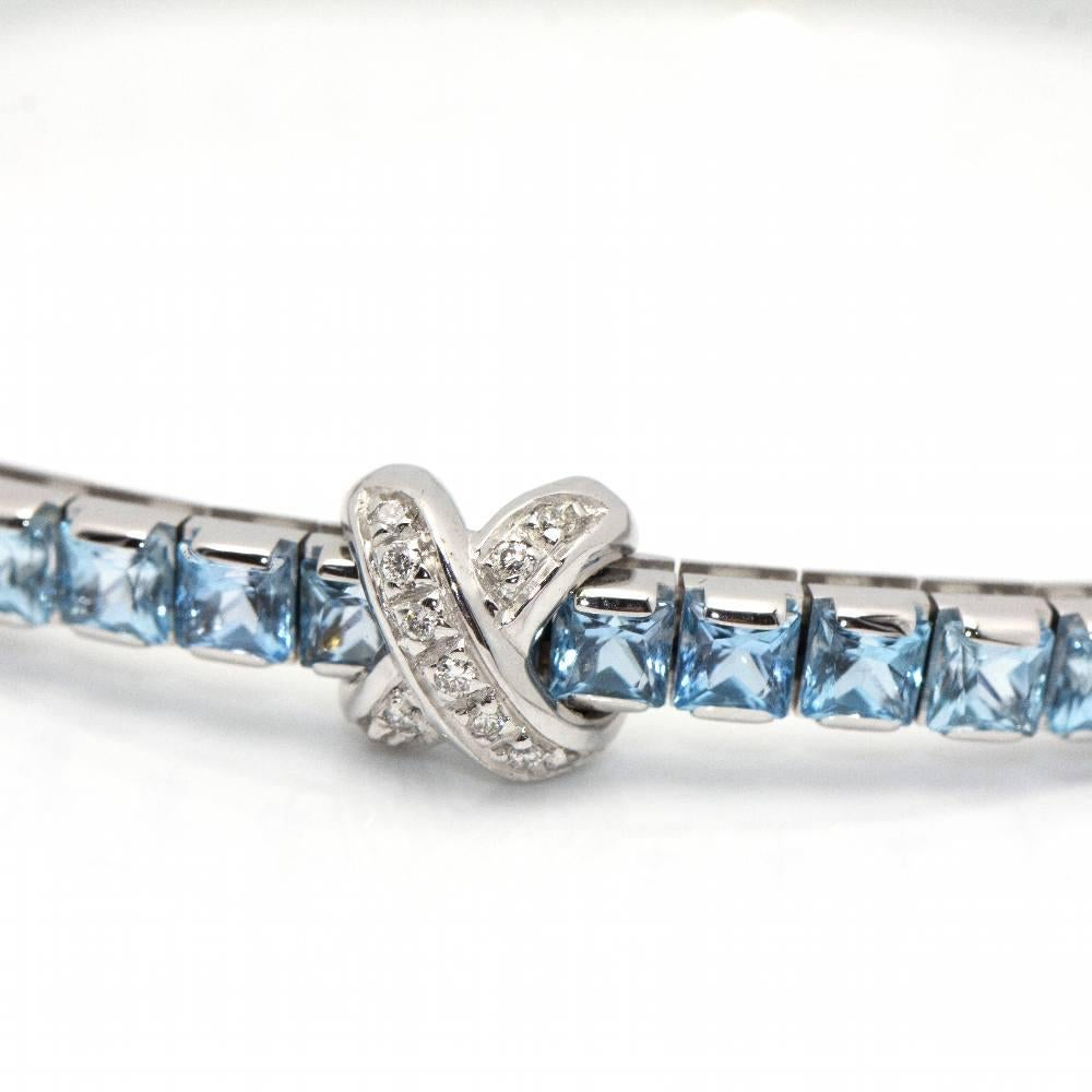 Italian design Riviere bracelet CENTOVENTUNO in Gold, Blue Topaz and Diamonds for woman  30x Brilliant cut Diamonds weighing 0,17cts. in G/Vs quality and 50x Blue Topazes  18kt White Gold  16,22 grams  Solid  Box clasp with 1x safety catch.  Size: