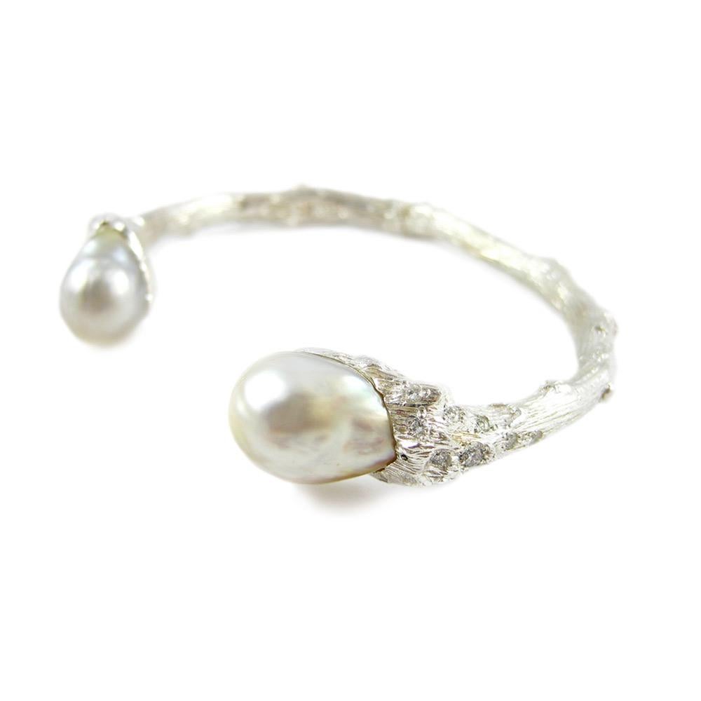 Channeling the eternal Tree of Life, the organic spirit of K. Brunini is captured through this hinged bypass bracelet in sterling silver artfully capped with South Sea pearls. Because all pearls are unique, each bracelet is a one-of-a-kind work of