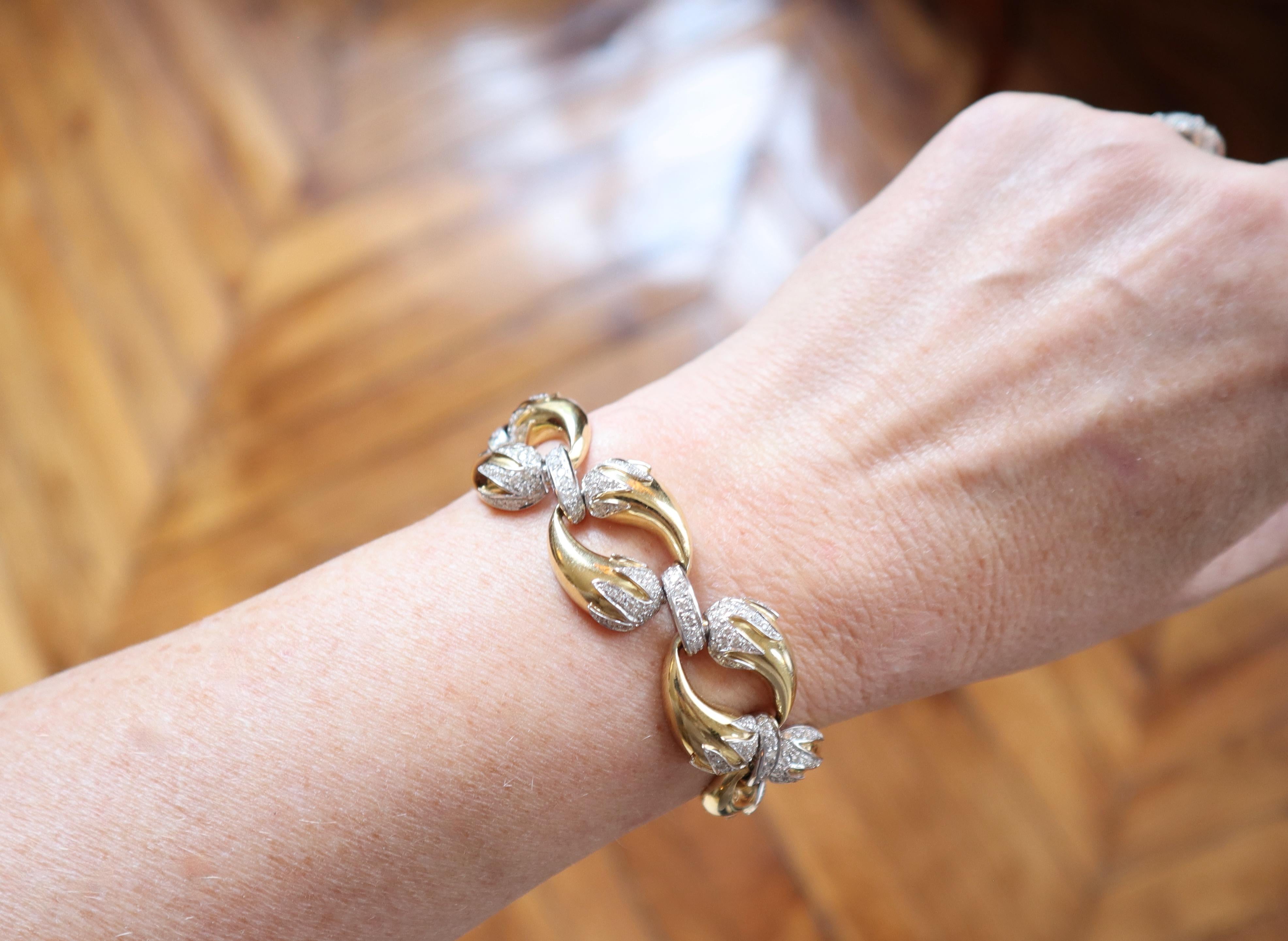 Horn of Abundance Bracelet circa 1960 in yellow and white Gold 18 Carat paved with Diamonds. The Bracelet is made up of rings composed of two Cornucopias head with white gold ends in white gold paved with Diamonds held together by passers in white