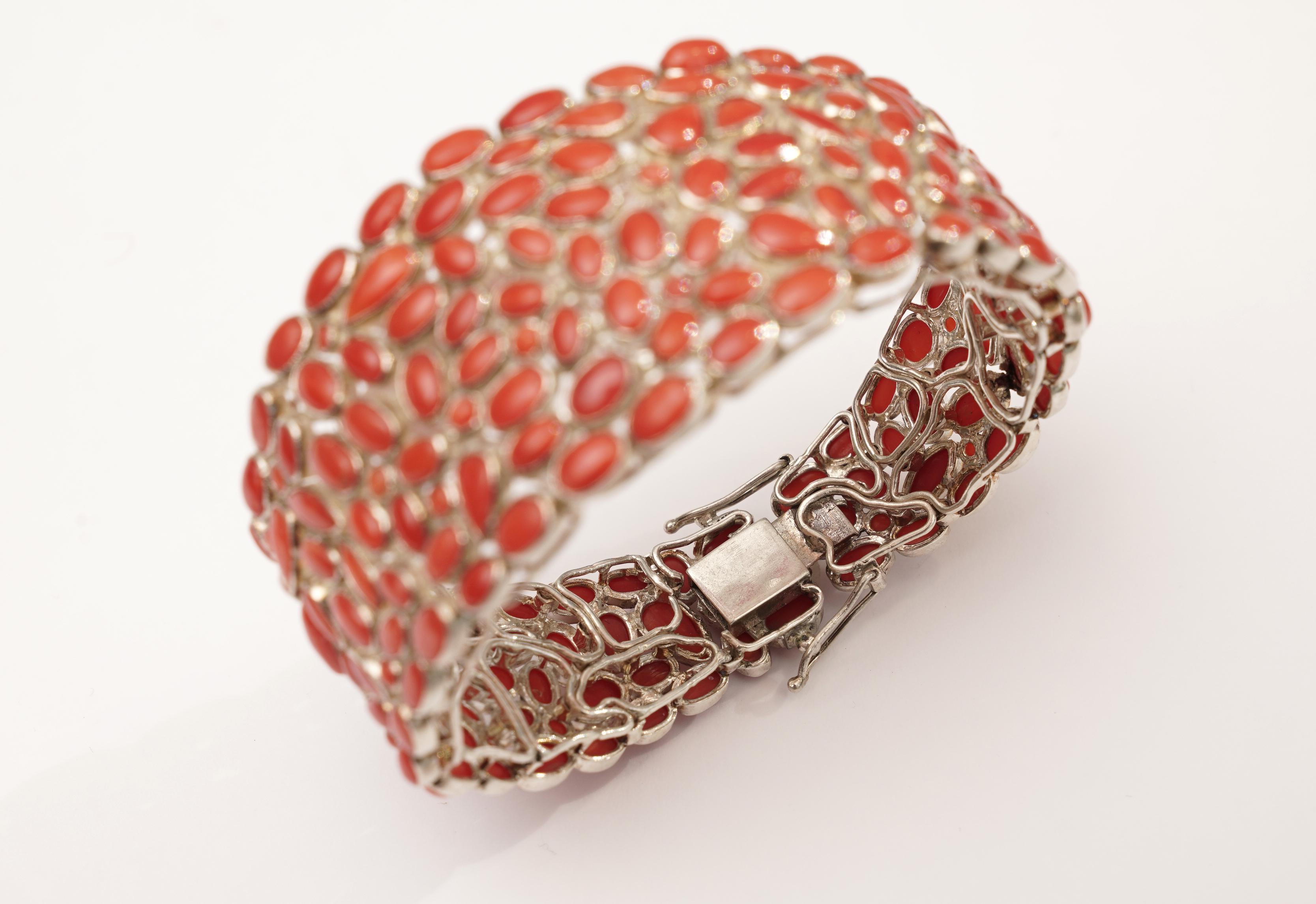 A mosaic of Italian coral individually set in sterling silver.  The bracelet is graduated ending in a push clasp with two safeties.  Incredible workmanship.  Inside circumference is 7 inches.