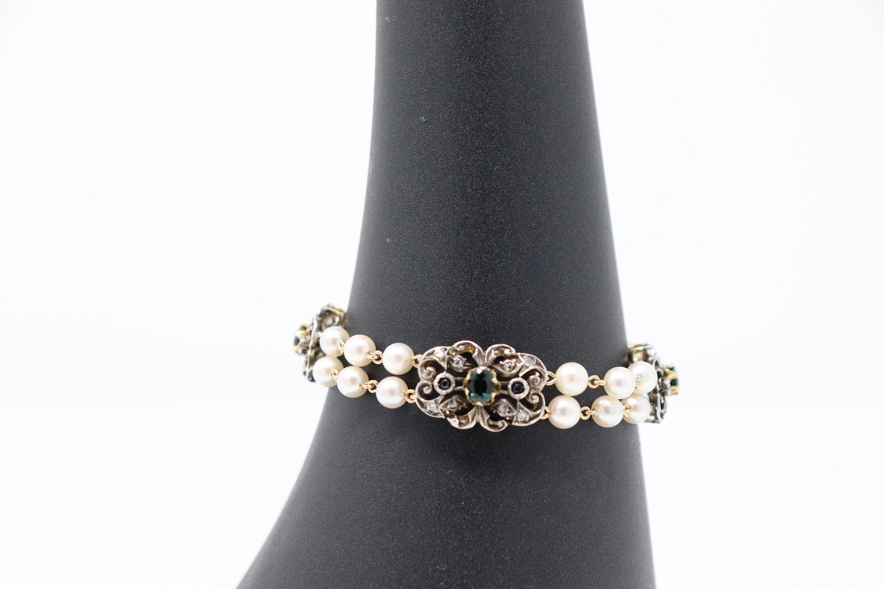 Refined bracelet with two strands of pearls in 18 Karat gold and 800 silver. The pearls are alternated with sapphires and diamonds mounted on medallion with floral decoration of great refinement. The closure is retractable. Very refined and elegant