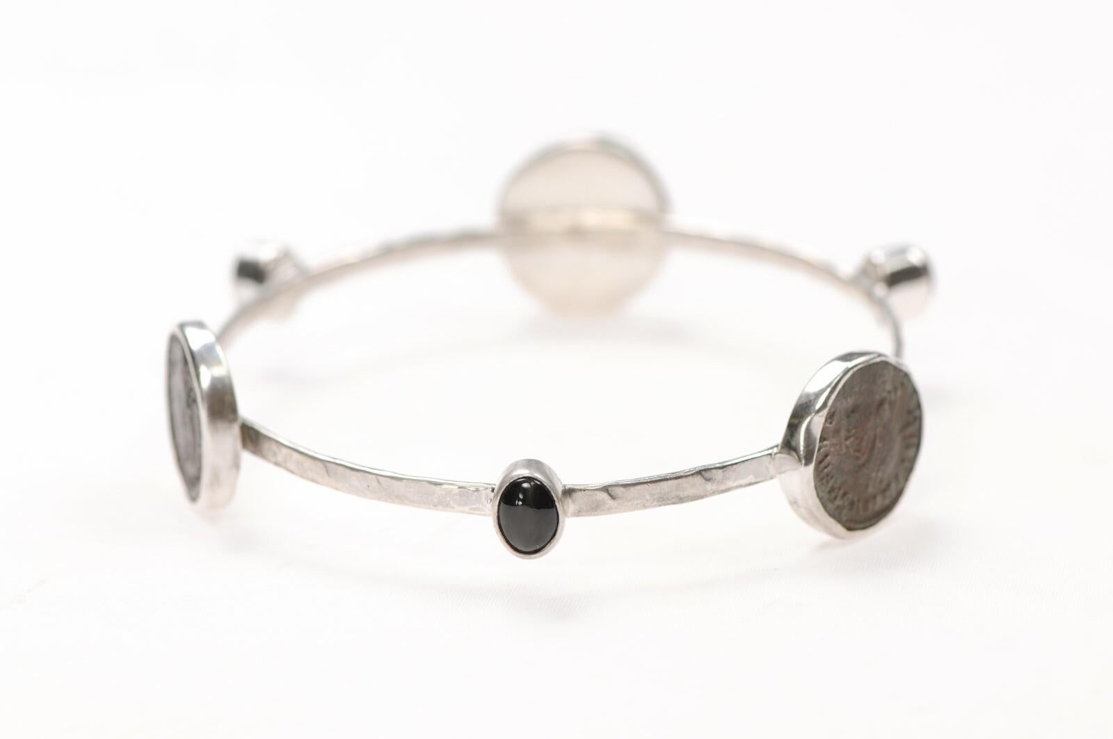A Bracelet with three diopside stones and three bronze Roman coins set in Sterling Silver. Bracelet dimensions are: 3.25
