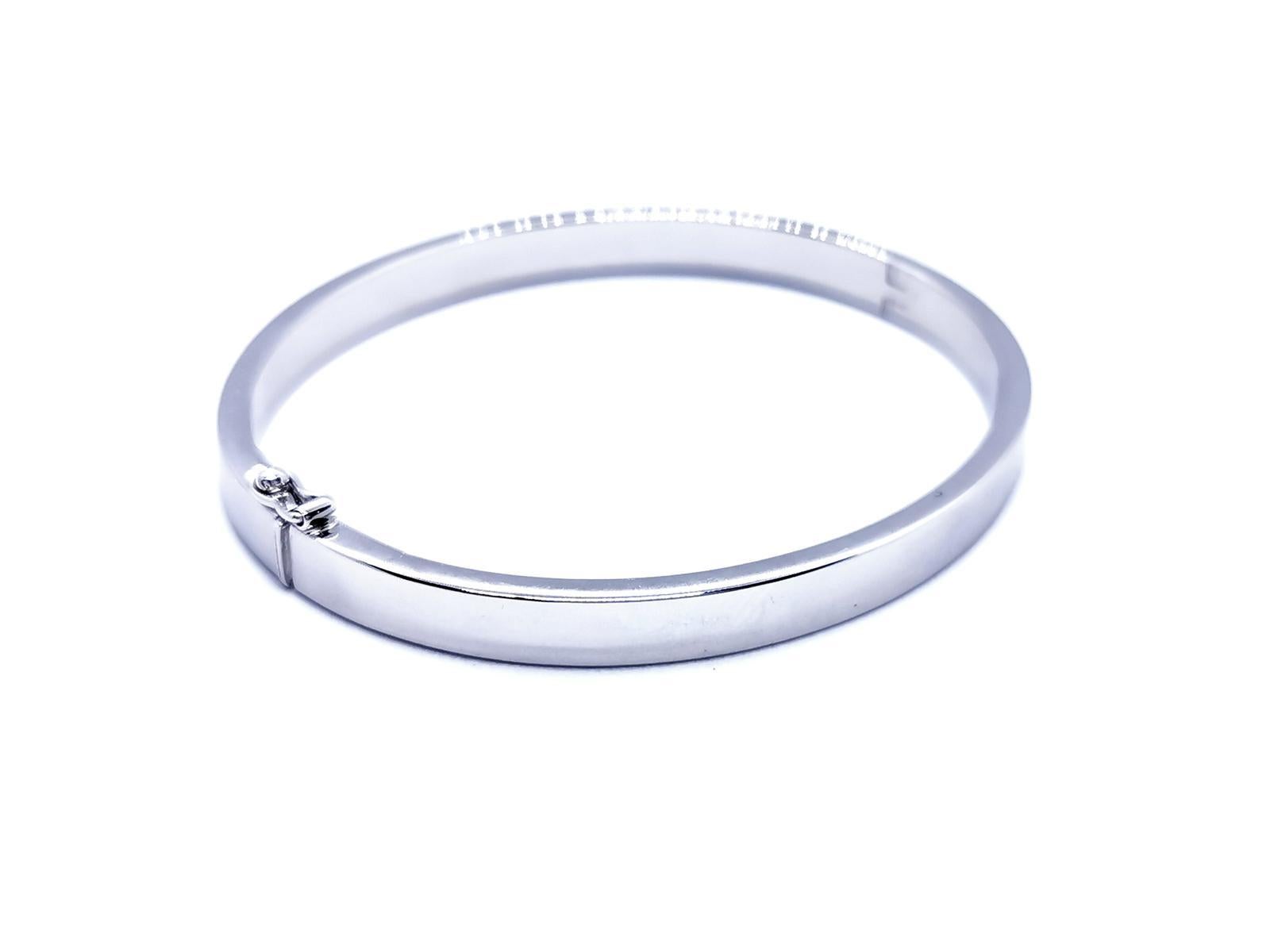 Bangle opening. white gold 750 mils (18K) and palladium. oval. clasp with eight safety. size: 18.5 cm. width: 0.57 cm. thickness: 0.25 cm. total weight: 40 . 66 g. punch eagle's head. excellent condition
