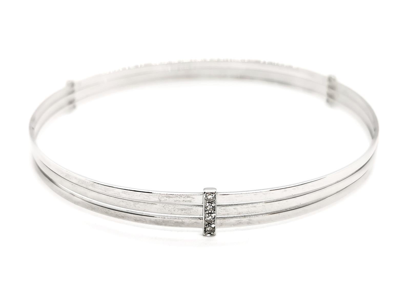 Diamond rush bracelet. in white gold 750 thousandths (18 carats). consisting of 3 gold threads. held by 3 lines of 4 brilliant diamonds. about 0.01ct each. total weight diamonds: about 0.12ct. length: 20.5 cm. width: 0.58 cm. total weight: 12.22g.