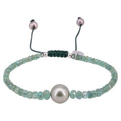 Bracelet with about 16 carat emeralds, one Tahiti pearl and drawstring closure