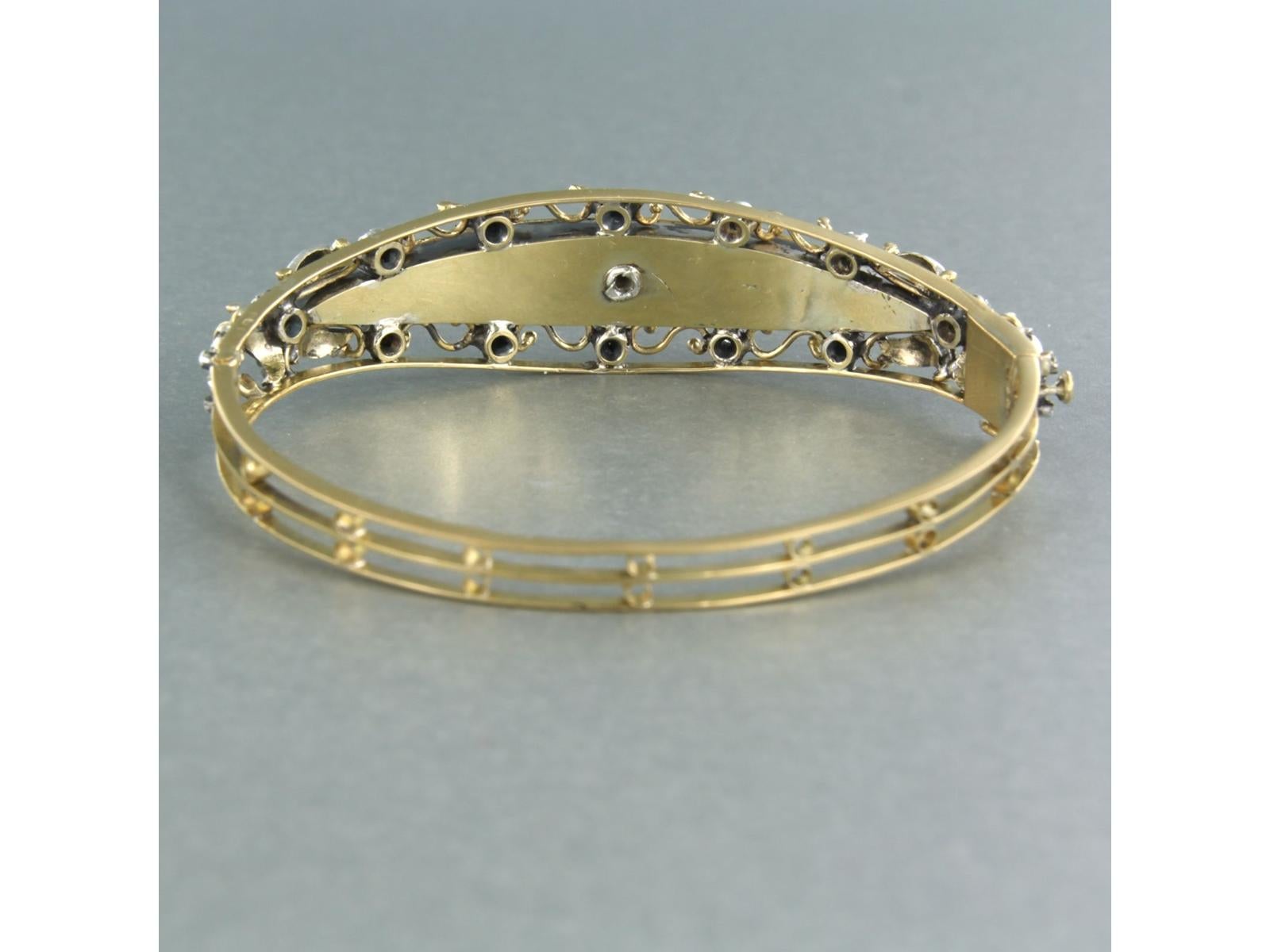 18k yellow gold bracelet with silver decorations and decorated with blue enamel set with rose diamonds set on silver - inner size 5.9 cm x 4.9 cm

detailed description:

the inner size of the bracelet is 5.9 cm by 4.9 cm wide

the center piece of