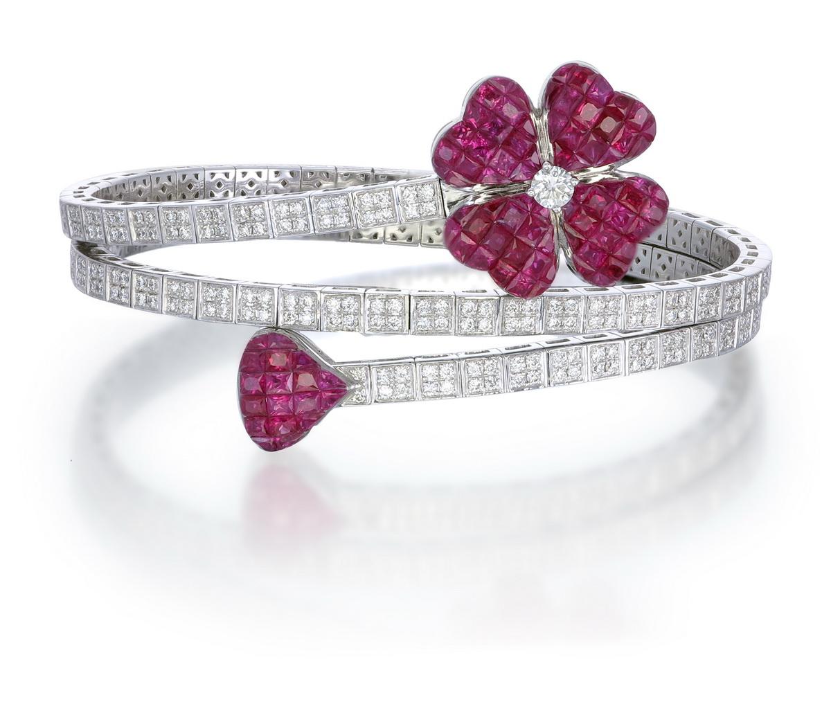 The diamond studded Gold stretch Bracelet makes this piece unique & special.

Made in 18kt gold with a ruby petal on one end & a heart shaped on the other end makes it one of its kind.

A little over 2.60 carat diamonds are used to make this