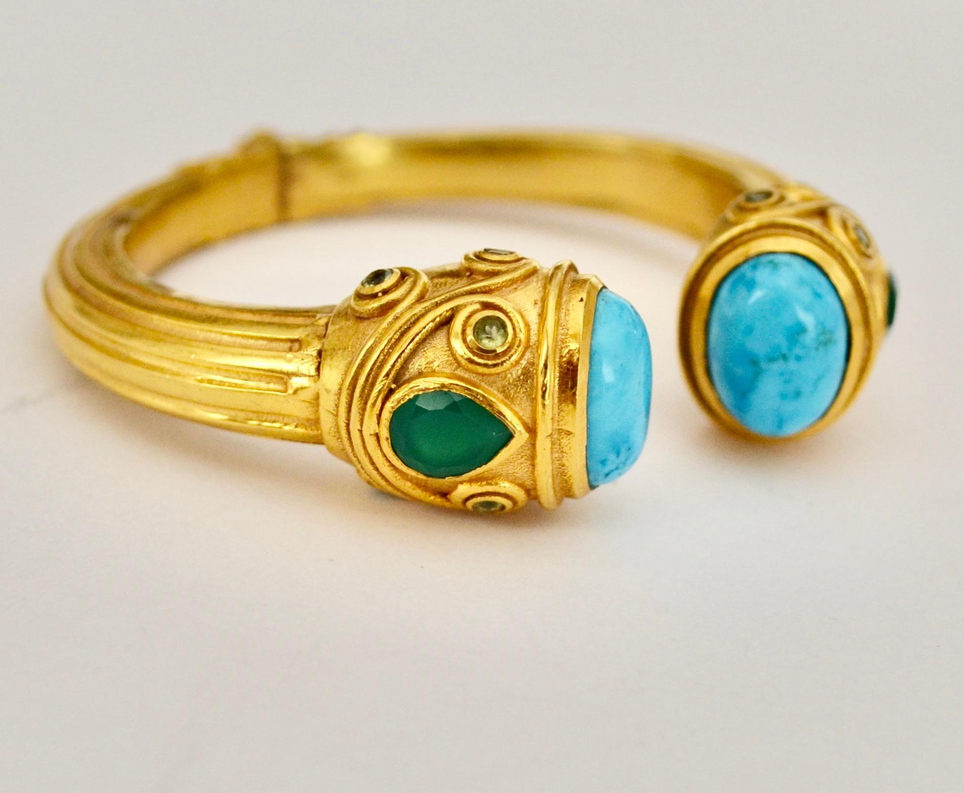 18-carat gilded brass hinged bracelet. Size is expendable. Turquoise, green onyx and aquamarine stones. Bracelet size opens from 2..4” to 5.2”
French designer