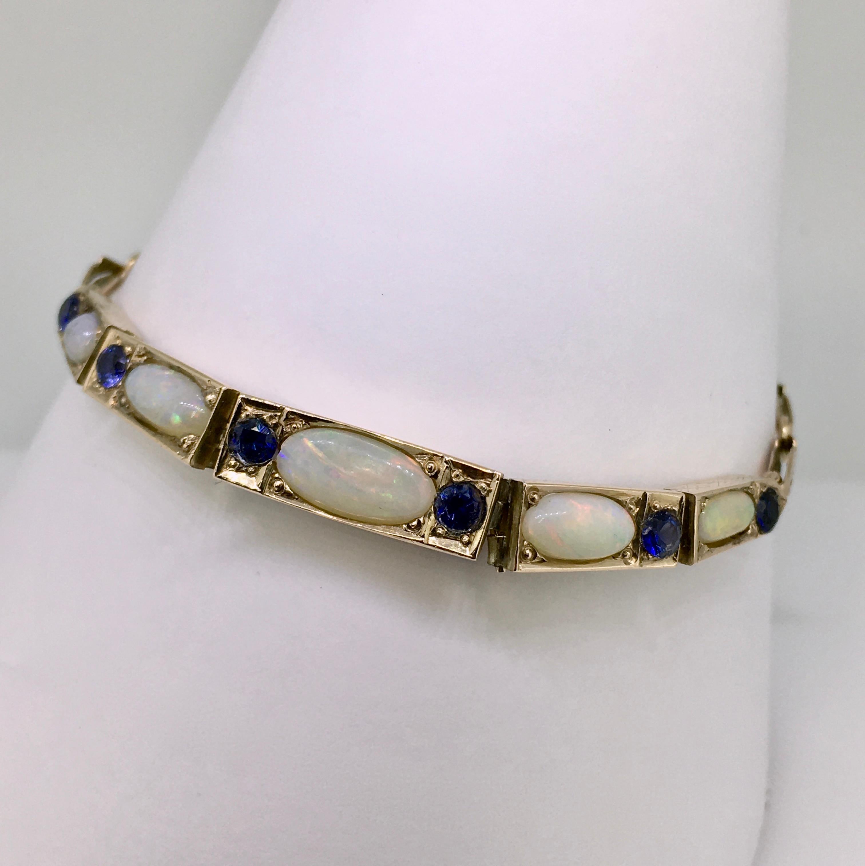 Yellow and pink gold bracelet, Late Art Deco style, set with Sapphire and White opal. 
The bracelet is in original condition, and has a warm patina, shown the warm pink gold links. 
A sparkling combination of the blue sapphires, opal and the pink