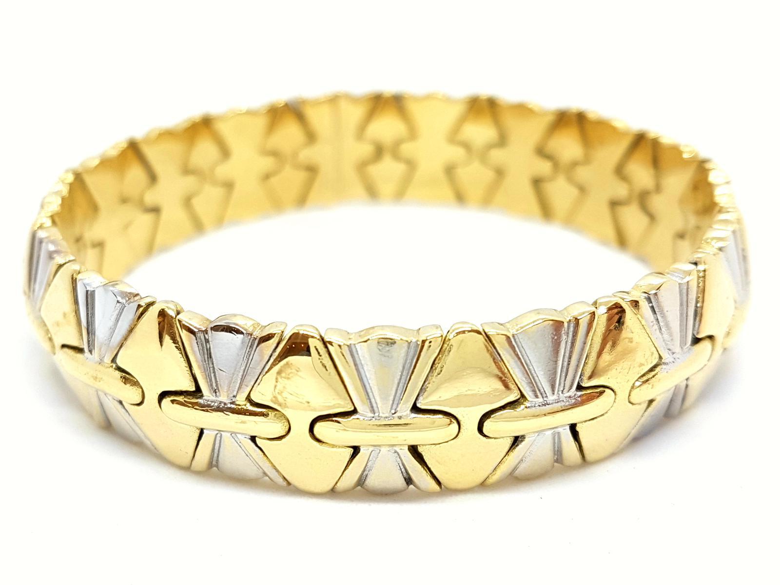 Bracelet Yellow Gold and White 750 mils (18 carats). rigid. semi-open. size: 19 cm. width: 1.2 cm. inner diameter 5.1 cm. weight: 58.93 g. punched. excellent condition
