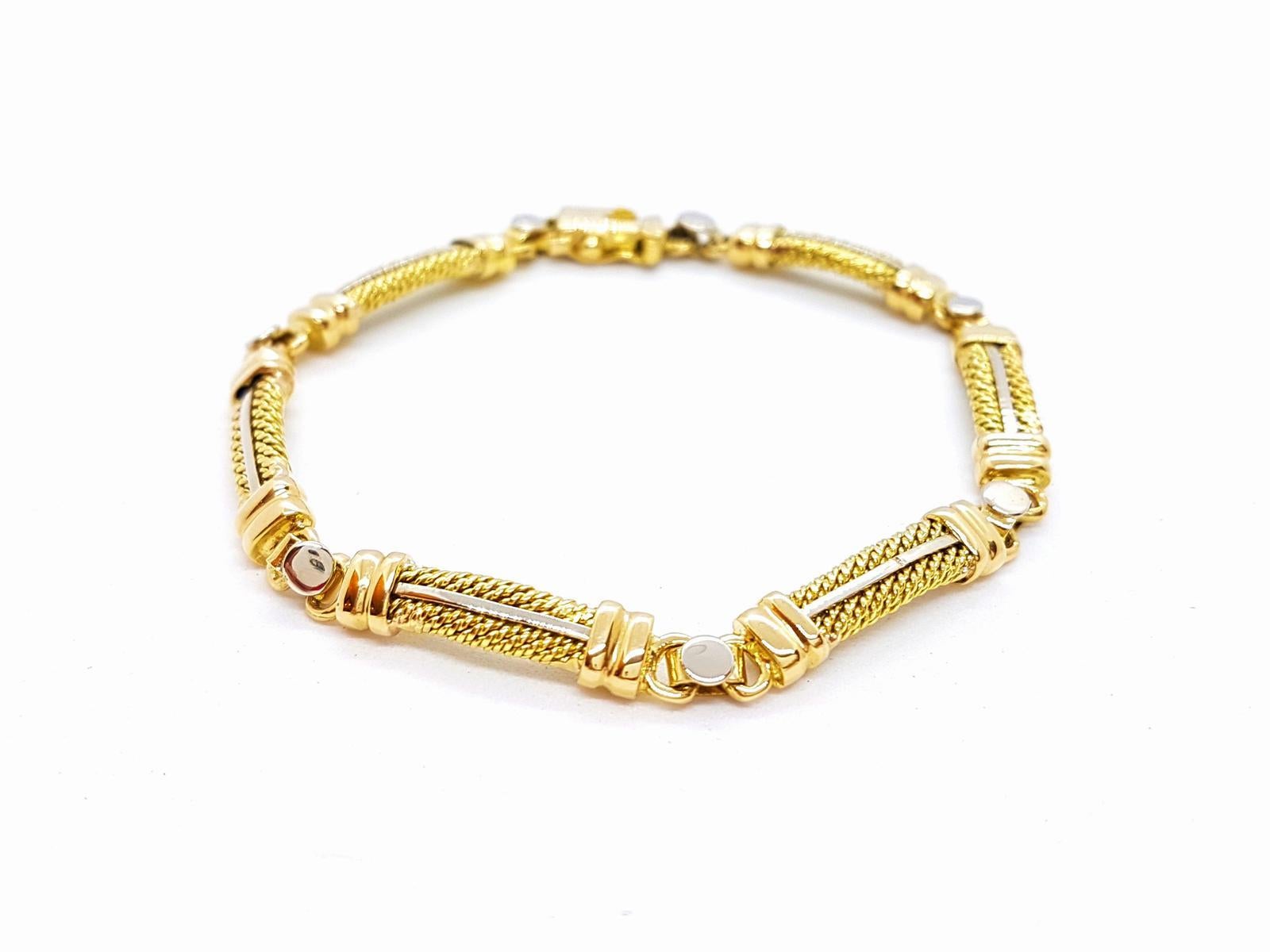 Bracelet yellow gold and white 750 mils (18K). composed of 6 bars. length: 18 cm. width: 0.52 cm. total weight: 18.95 g. punched. excellent condition
