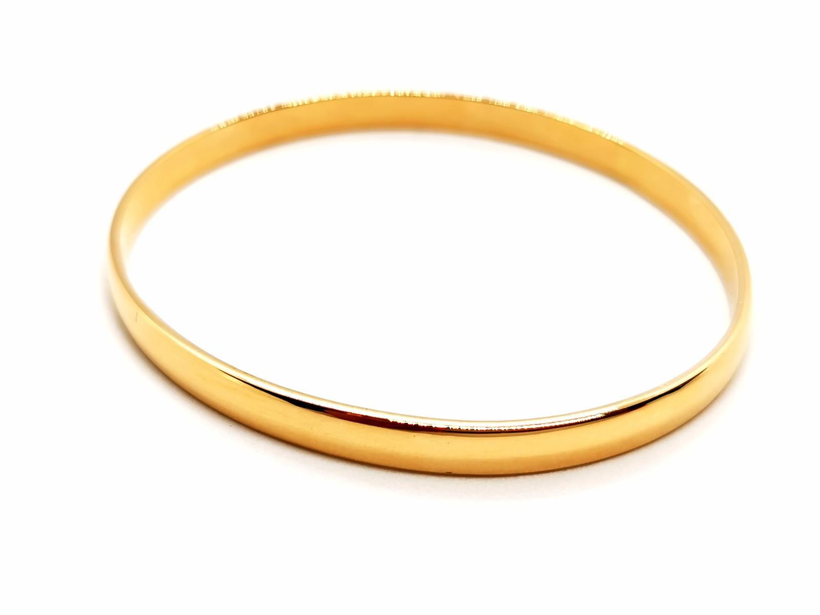 half bangle. gold yellow 750 mils (18 carats). curved oval shape. solid. inner diameter: 6.3 cm x 5.6 cm. height: 19 cm. width: 0.50 cm. total weight: 22 . 19 g. eagle head punch half erased. excellent condition.
