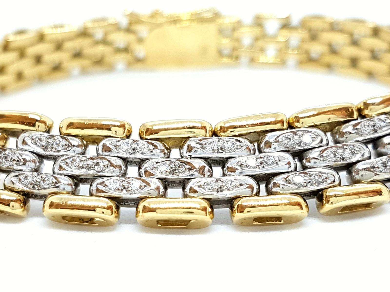 Bracelet bicolor yellow gold and white 750 mils (18 carats). pad 38 of diamonds to about 0.19 ct total metalled The links are made of white gold. width: between 1 cm (paved portion diamonds) and 0.8 cm ( clasp side). length: 19 cm. punched. Weight: