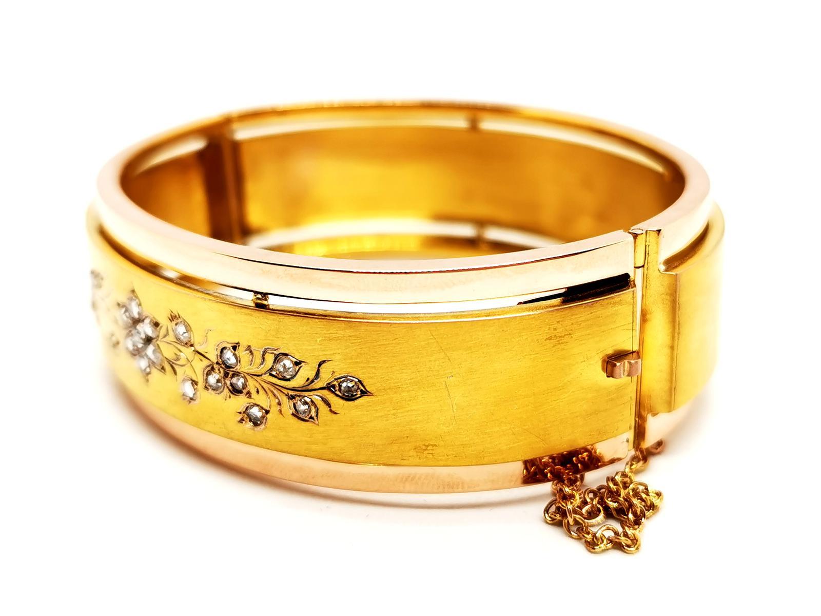 Old gold and diamond cuff bracelet. second half of the 19th century. in yellow and pink gold 750 thousandths (18 carats). in the center a matt yellow gold band. enhanced with an engraved floral motif. set with 22 old cut diamonds. weight total