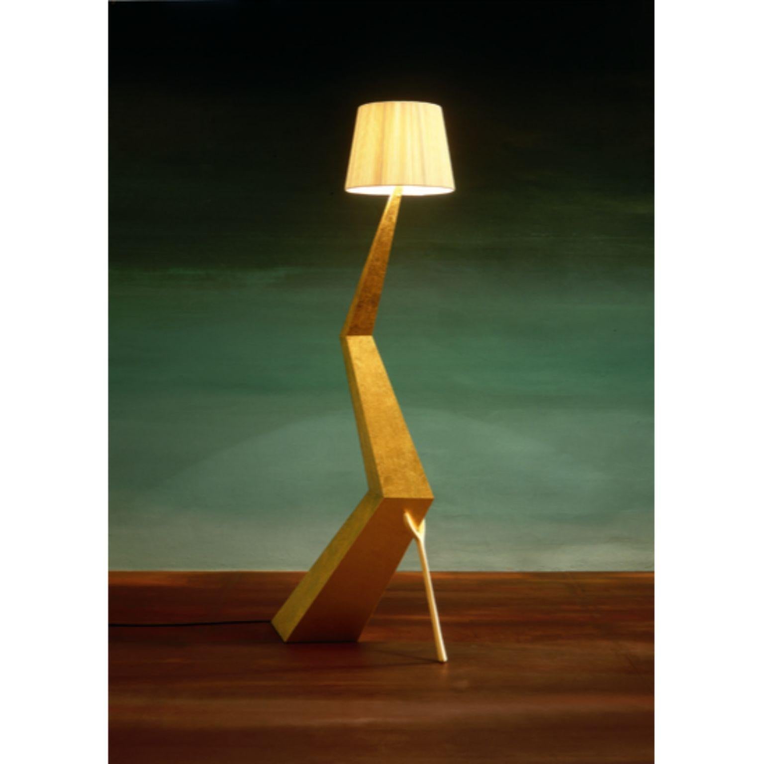 Bracelli lamp, Salvador Dalí.
Dimensions: 64 x 37 x 180 H cm.
Materials: Wooden board structure.
Ivory colored cotton and rayon fabric.

The Bracelli lamp has a wooden board structure covered in fine gilding also available in a darker version.