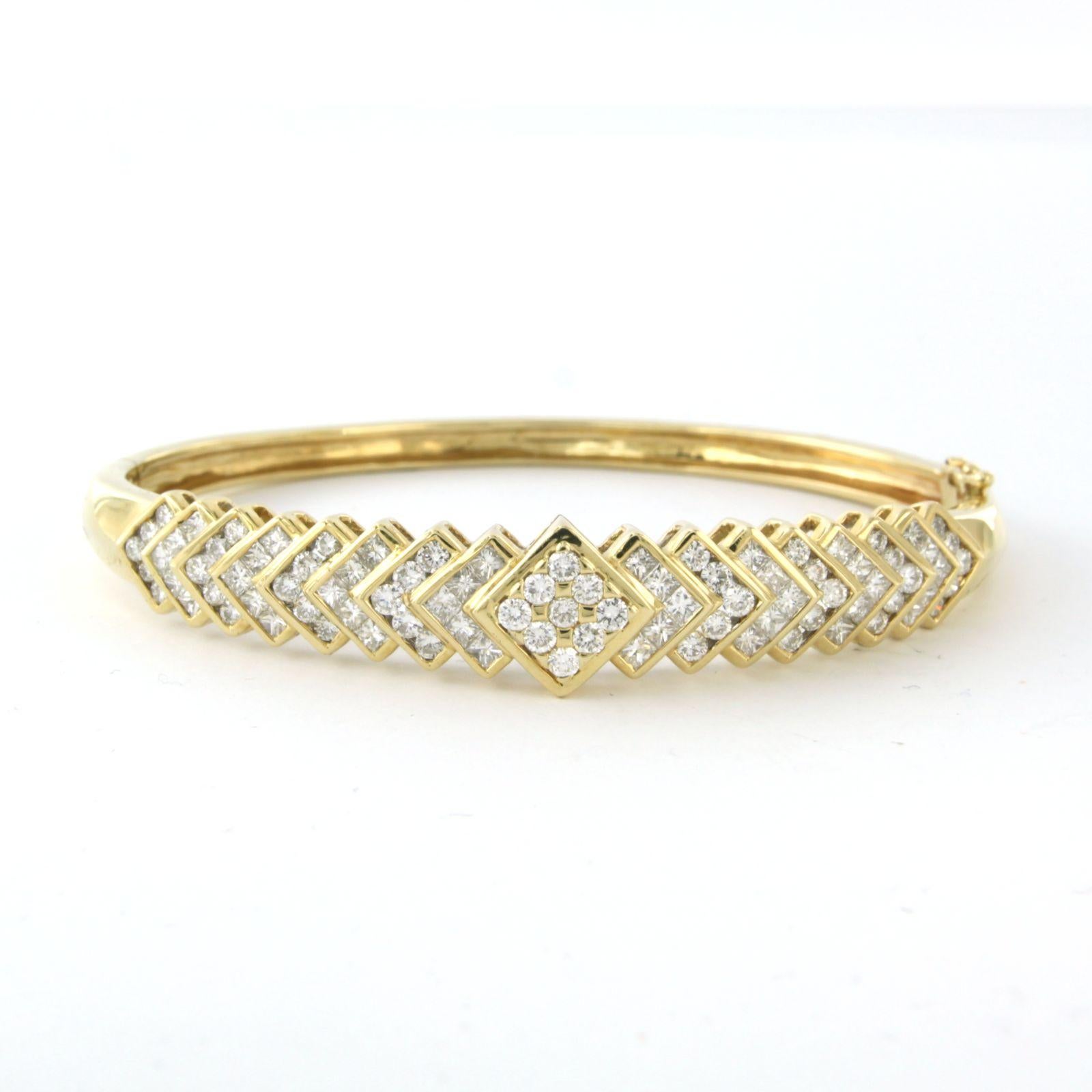 14k yellow gold clamper bracelet set with princess and brilliant cut diamonds. 2.50ct - F/G - VS/SI - inner size 5.7 cm x 4.7 cm

detailed description

the top of the bracelet is 1.0 cm wide by 7.5 mm high

inner size of the bracelet is 5.7 cm wide