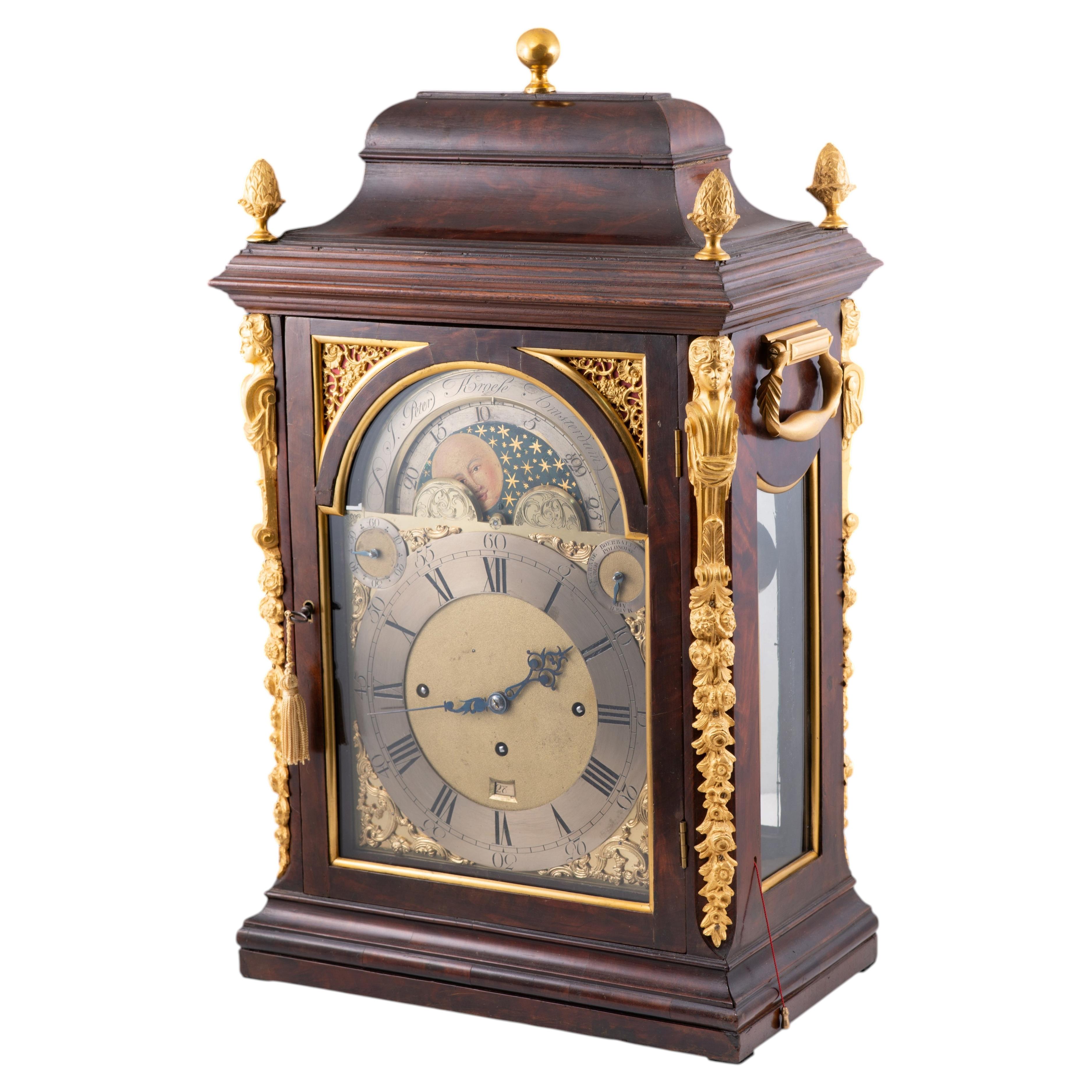 Bracket clock with moon dial and mahogany wood case. Amsterdam, 18th c.