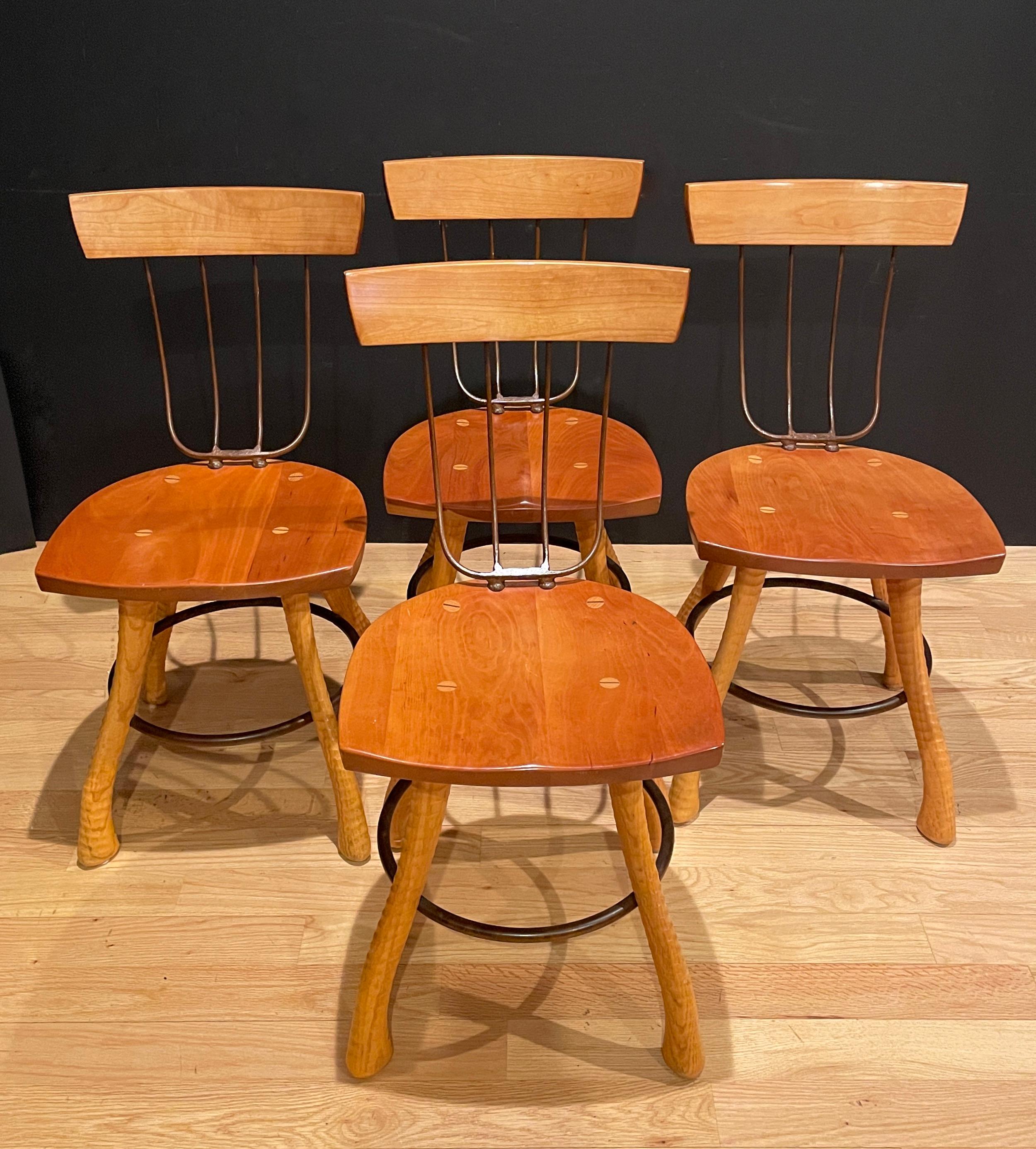Uniquely designed wood and iron chairs. Farmhouse country style with pitchfork form wrought iron chair back and ax handle form legs supported by through dowels and iron ring. Designed and bench made by Bradford Woodworking of Worcester, Pennsylvania.