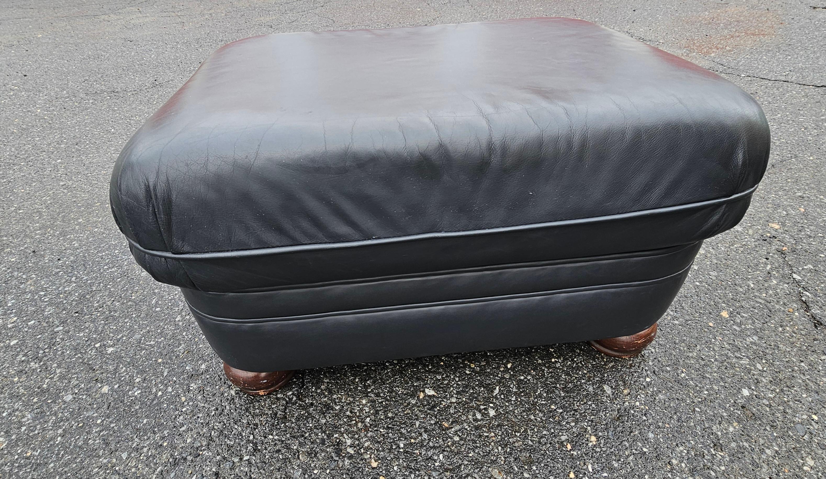 A black  top grain leather ottoman by Brafington Young in very good vintage condition. Measure 20