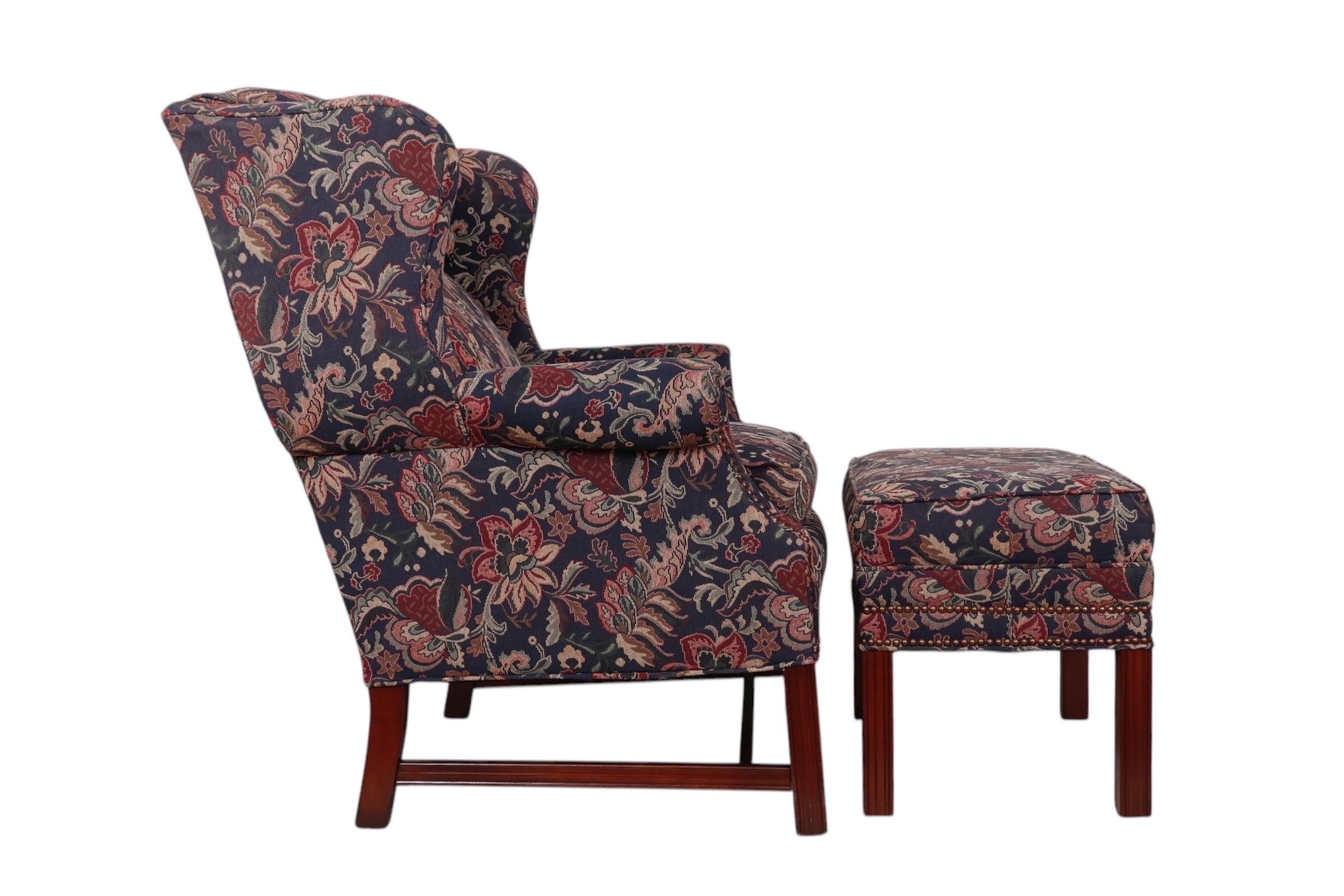 An English Georgian style wingback chair and matching ottoman made by Bradington Young of North Carolina. Curvaceous wings flank the reclining back, which meets a square seat framed with outward rolled panel arms. Upholstered throughout with a