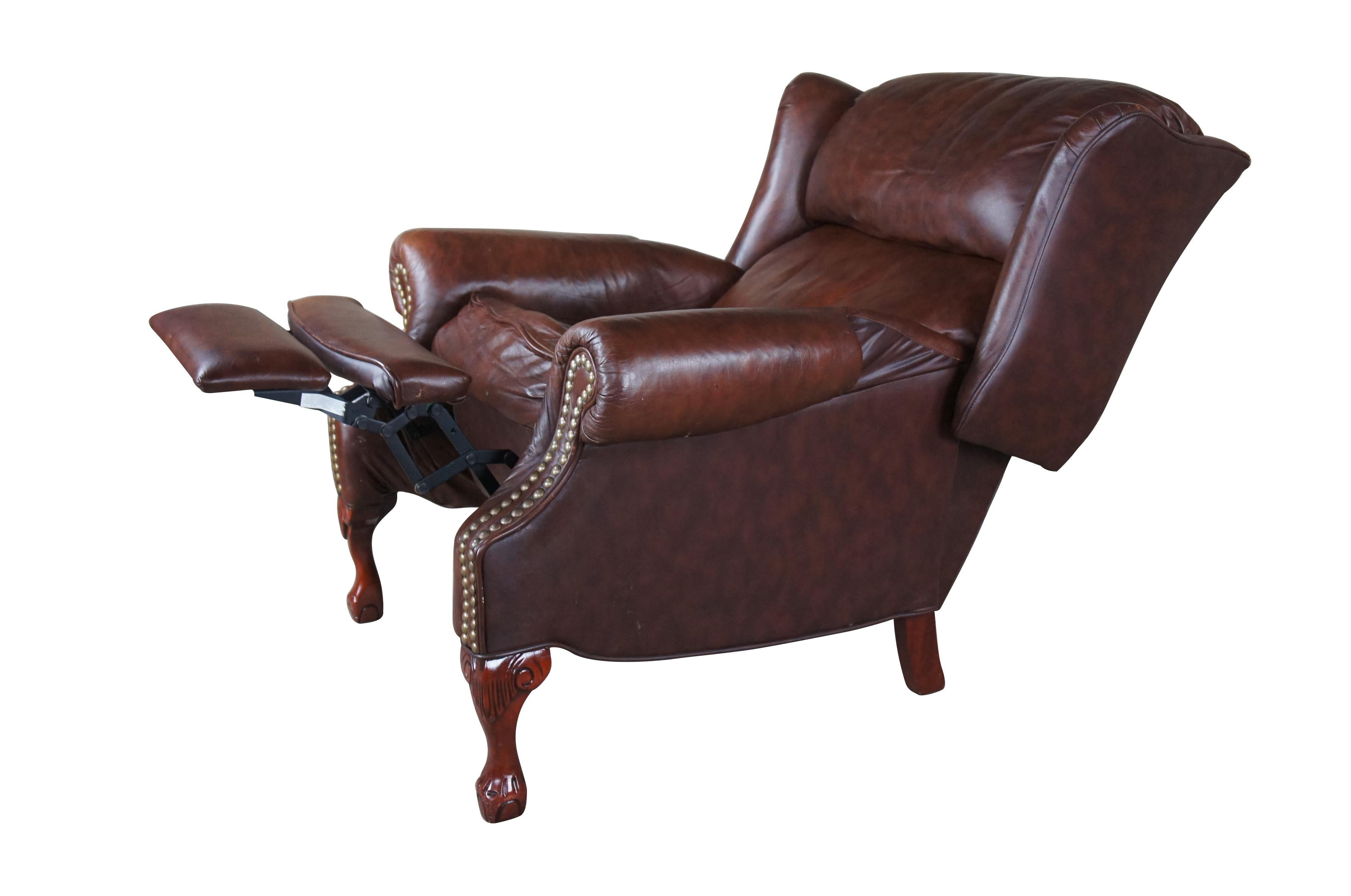 Vintage Bradington Young Maxwell Wingback Club Chair.  Drawing inspiration from iconic chippendale styling.  Features rolled arms, nailhead trim and acanthus carved ball and claw feet.   Chair reclines by pushing back along the seat.  Made in