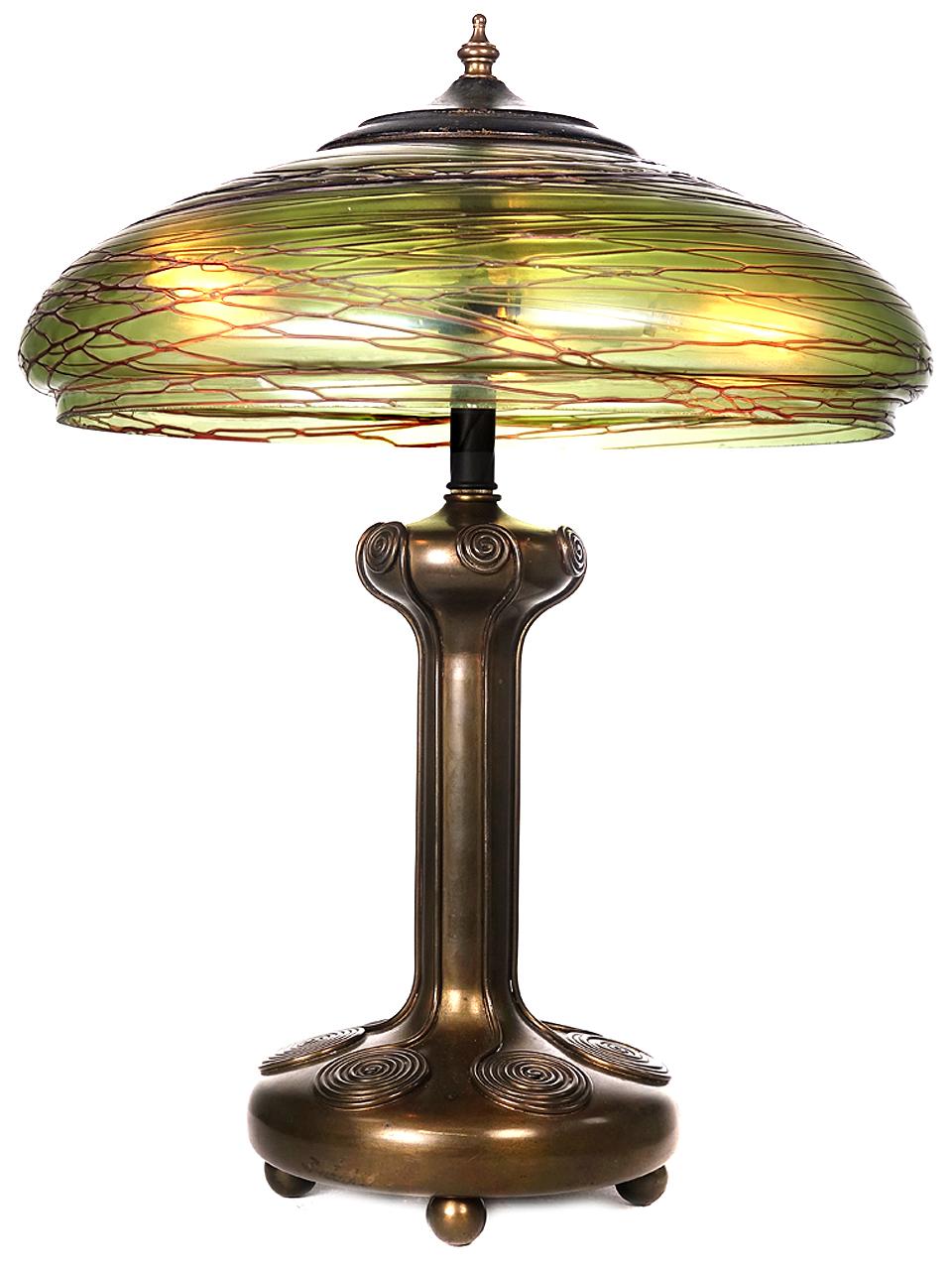 I have plenty of lamps but this is one I'd like to bring home. The hand finished details on the base and the shade have just the right look. The amber and green glass has the feel of dragonfly wings. The shape is very Arts & Crafts.