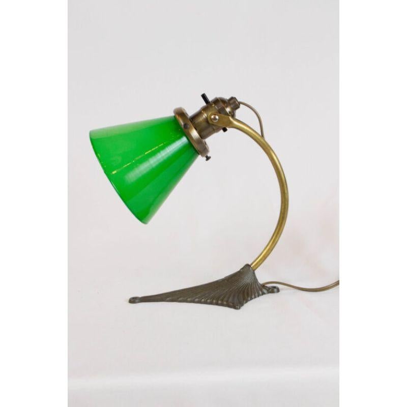 Convertable Lamp, can be hung on the wall or used as a small desk lamp. Includes Glass. metals are completely restored, and the lamp is newly rewired. Stamped Bradley & Hubbard. C. 1910

Dimensions: 
Height: 8
Width (Diameter): 5