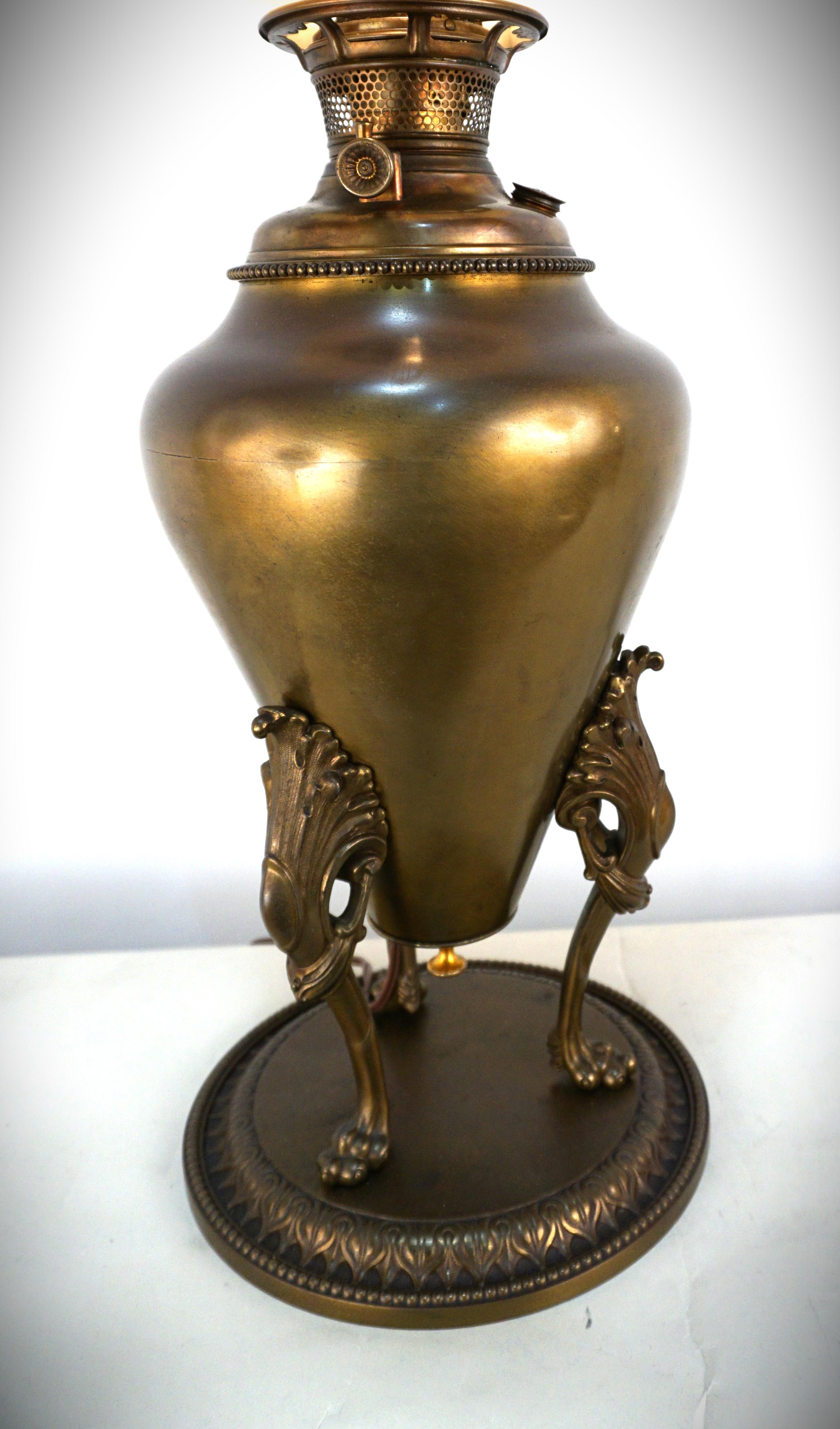 19th century electrified beautiful patina brass and brass plate oil lamp with hand painted glass shade.
Painting on glass influenced by Bergman Austrian sculptor and painter.
Professionally electrified. 