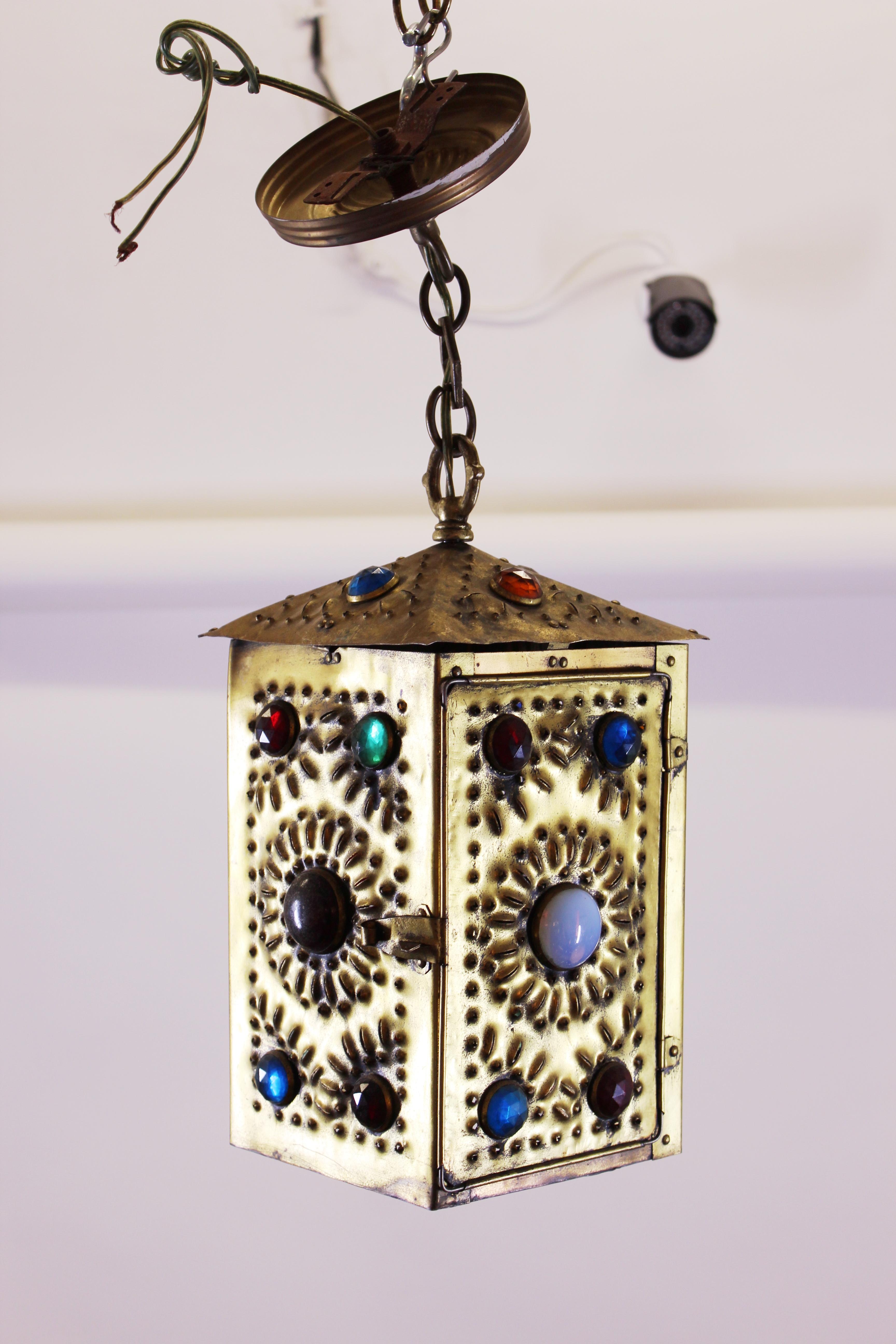 Bradley and Hubbard American Aesthetic Movement handmade lantern in hand-pierced brass with opalescent and faceted glass jewels and a hinged door, open to the bottom, made during the 1880's. In remarkable antique condition with age-appropriate wear.