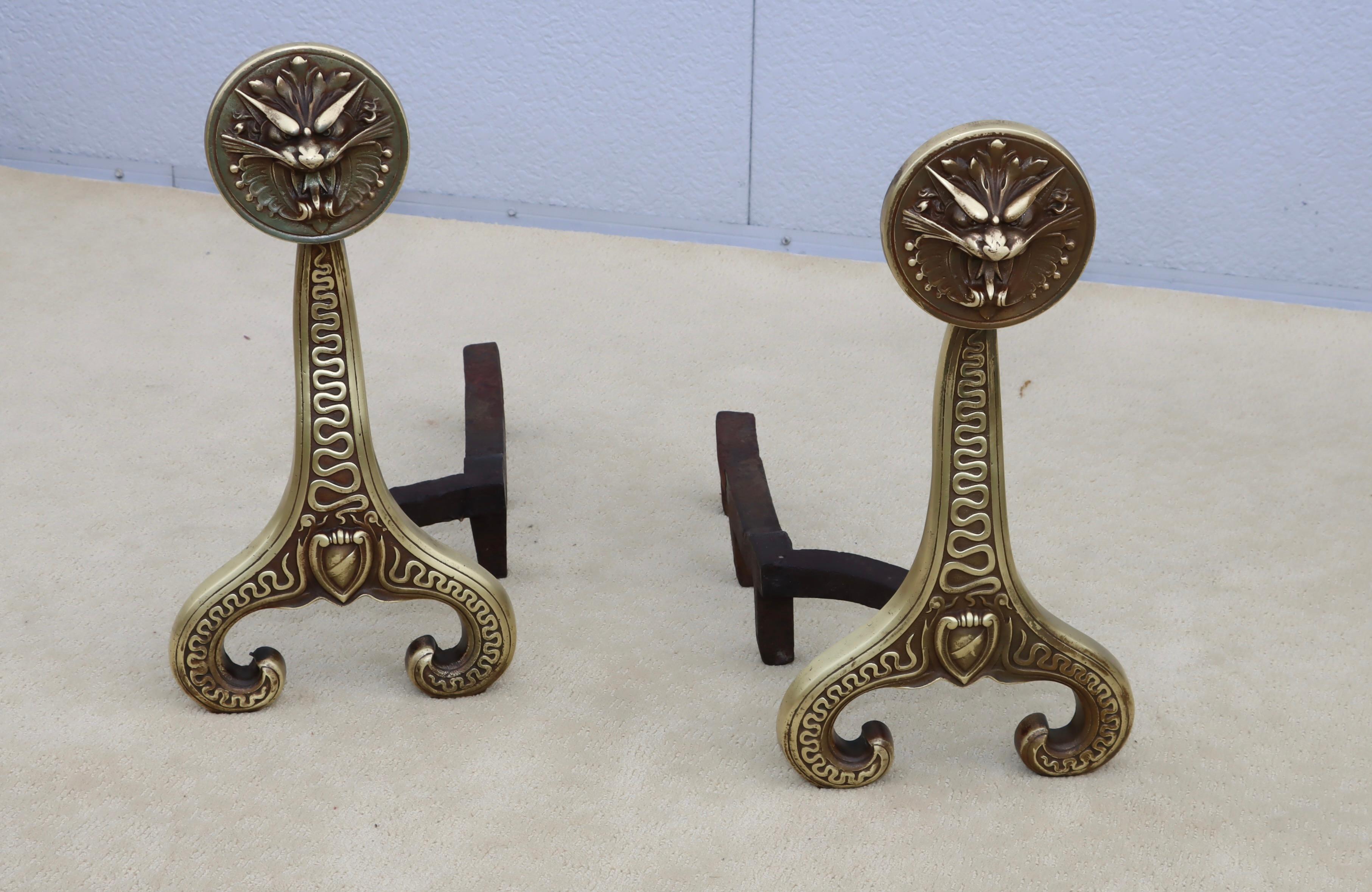 Amazing pair of 1886 solid brass and iron andirons by Bradley & Hubbard, in vintage condition with some wear and patina to the brass due to age and use, the brass was lightly hand polished.