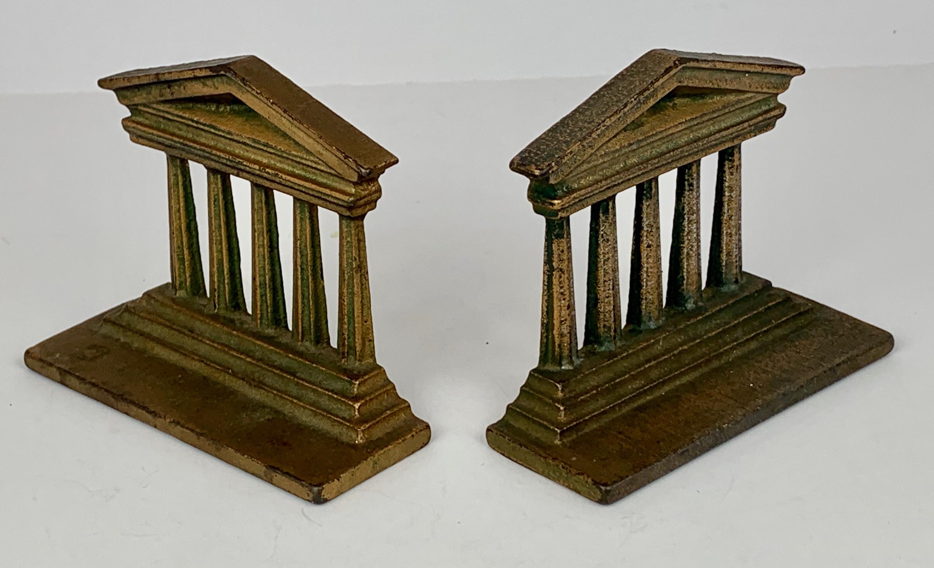 Pair of cast iron temple bookends by Bradley & Hubbard Manufacturing Company who operated in Meriden, Connecticut from 1852-1940. Nicely patinated and perfect for books on a desk or just neoclassical objects for any surface.