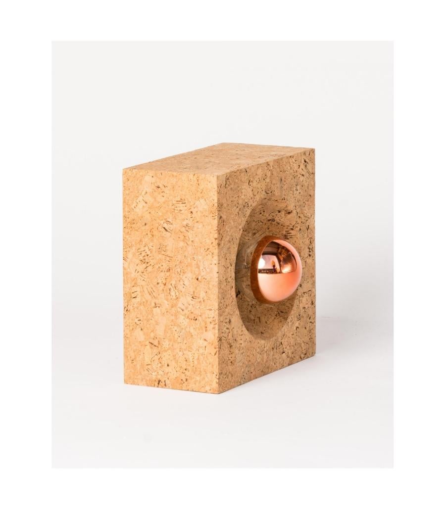 Minimalist cork table lamp or wall light by Facto Atelier Paris. Made of recycled cork stoppers and burnt finish natural cork in Portugal. Lamps can be either wired as wall fixtures or as table lamps. 
Price does not include shipping nor possible