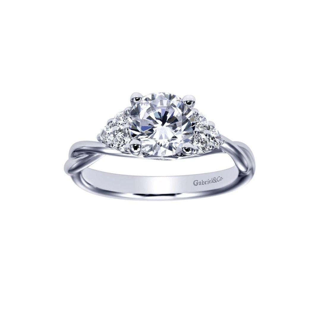 Braided White Gold Diamond Engagement Mounting. Two delicate florette clusters of natural white diamonds discretely flank the center stone. Center diamond NOT included. Side diamonds weigh a total carat weight of 0.20 ctw, H color, SI clarity.