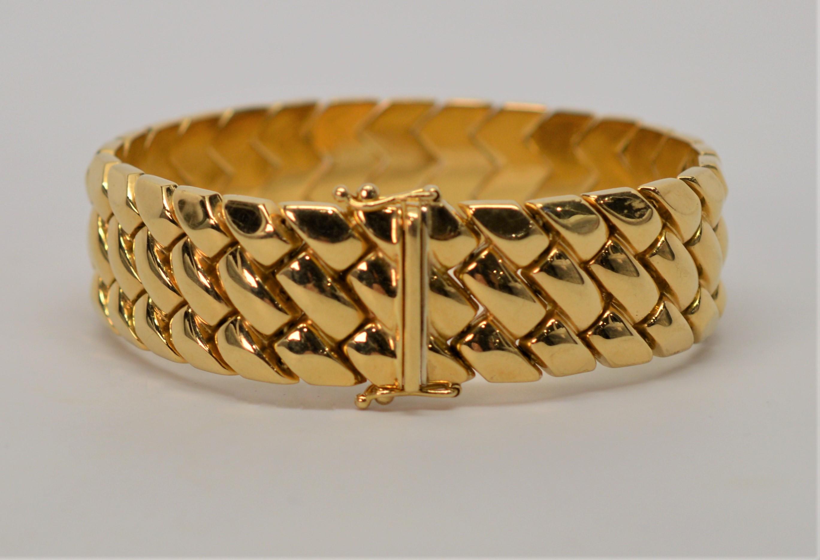 A bright, bold classic band of beautiful eighteen karat 18K yellow gold for every occasion. Excellent quality Italian construction at seven inches in length and 5/8 inch wide, the braided or weave style links give dimension and interest to the high