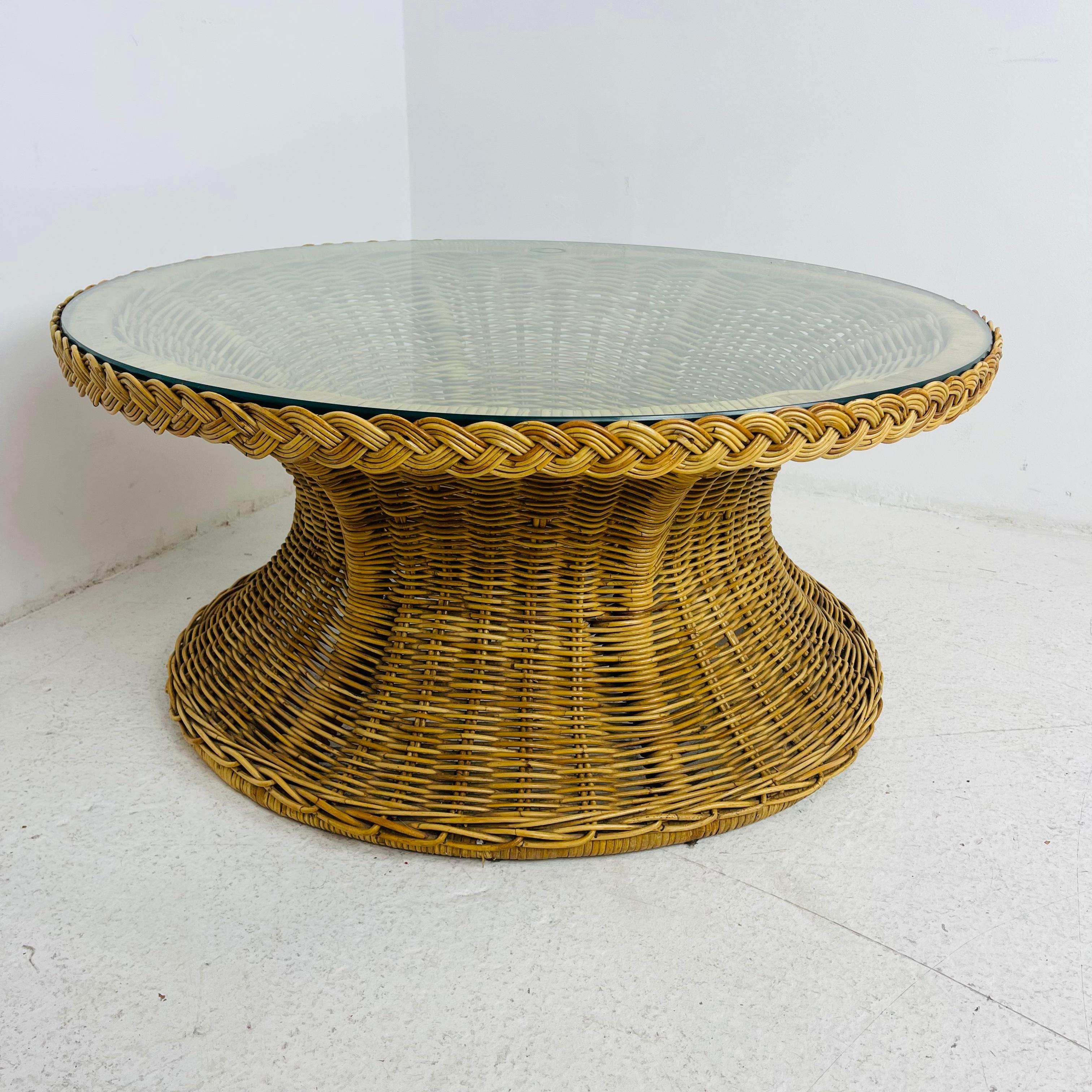 Wicker Works glass top coffee table with signature braided rattan edging. Some very minor imperfections (pictured) but overall great condition.