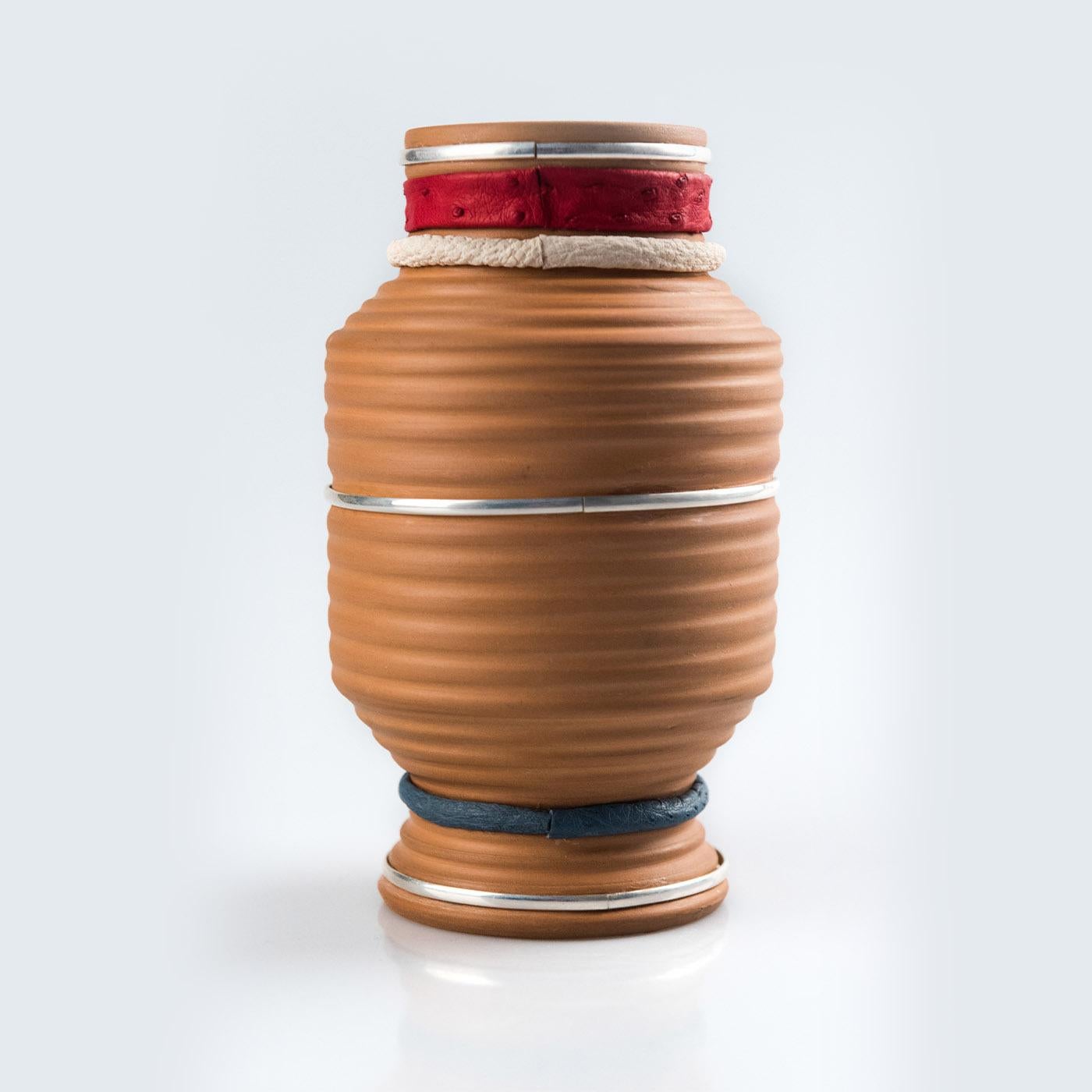 A refined accent piece for both traditional and modern interiors, this gorgeous vase is a stupendous showcase of craftsmanship. Handmade of first-rate materials, it is fashioned of earthenware, finished with beeswax, and adorned with silver 925
