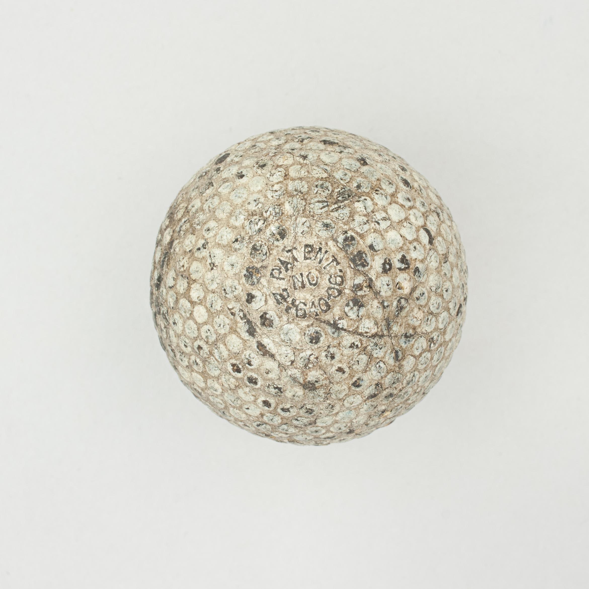 A good example of a bramble patterned rubber core golf ball. The golf ball is in good condition and is manufactured by St. Mungo Manufacturing Co. The ball is marked 'The Colonel' on one pole, 'Patent No. 2164006' on the other and is with the