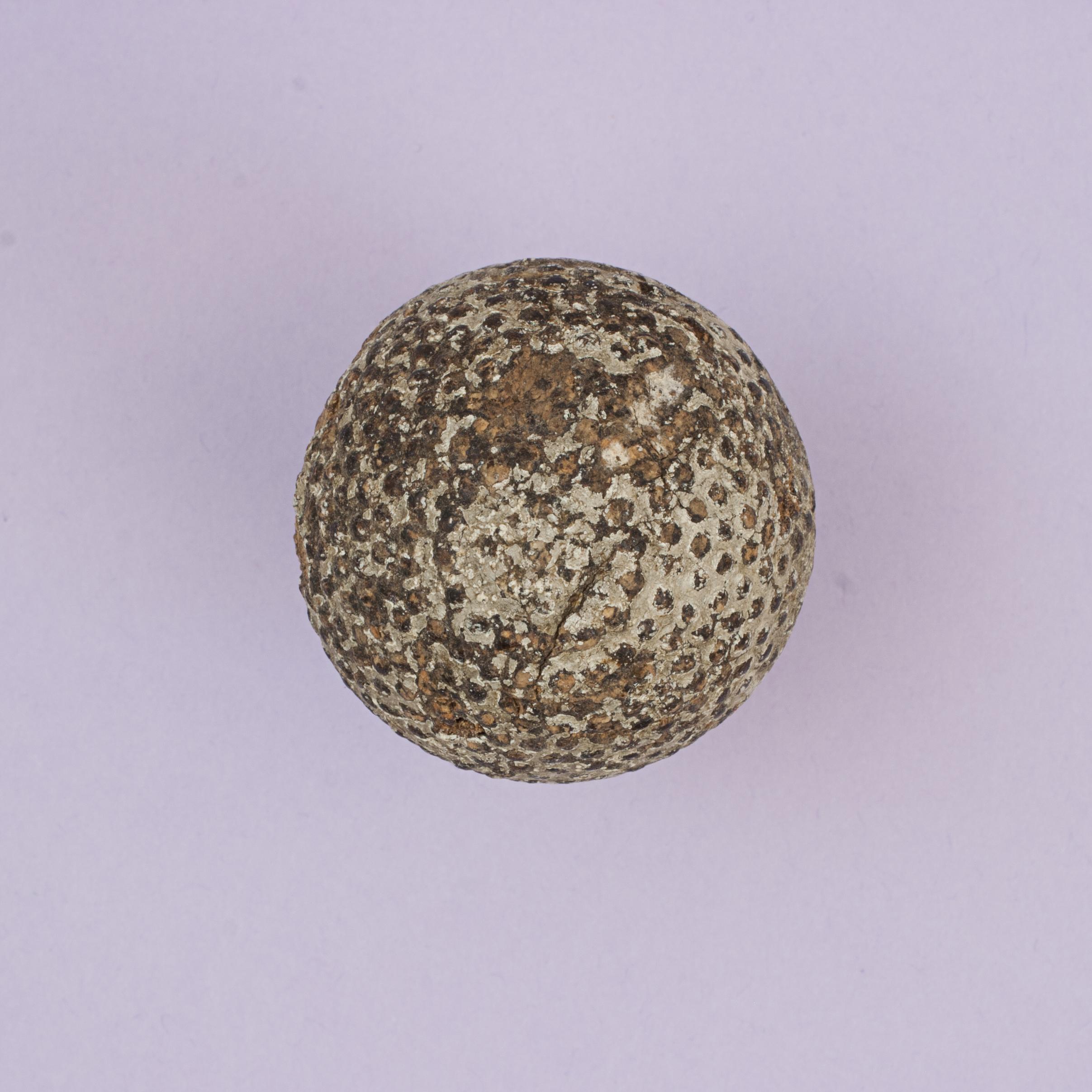 Rubber Core Bramble Golf Ball.
A very nice named bramble pattern golf ball with some remnants of paint on the surface. The gutta percha covered, rubber core, golf ball with a name on one pole but with indistinct lettering. The balls name with raised