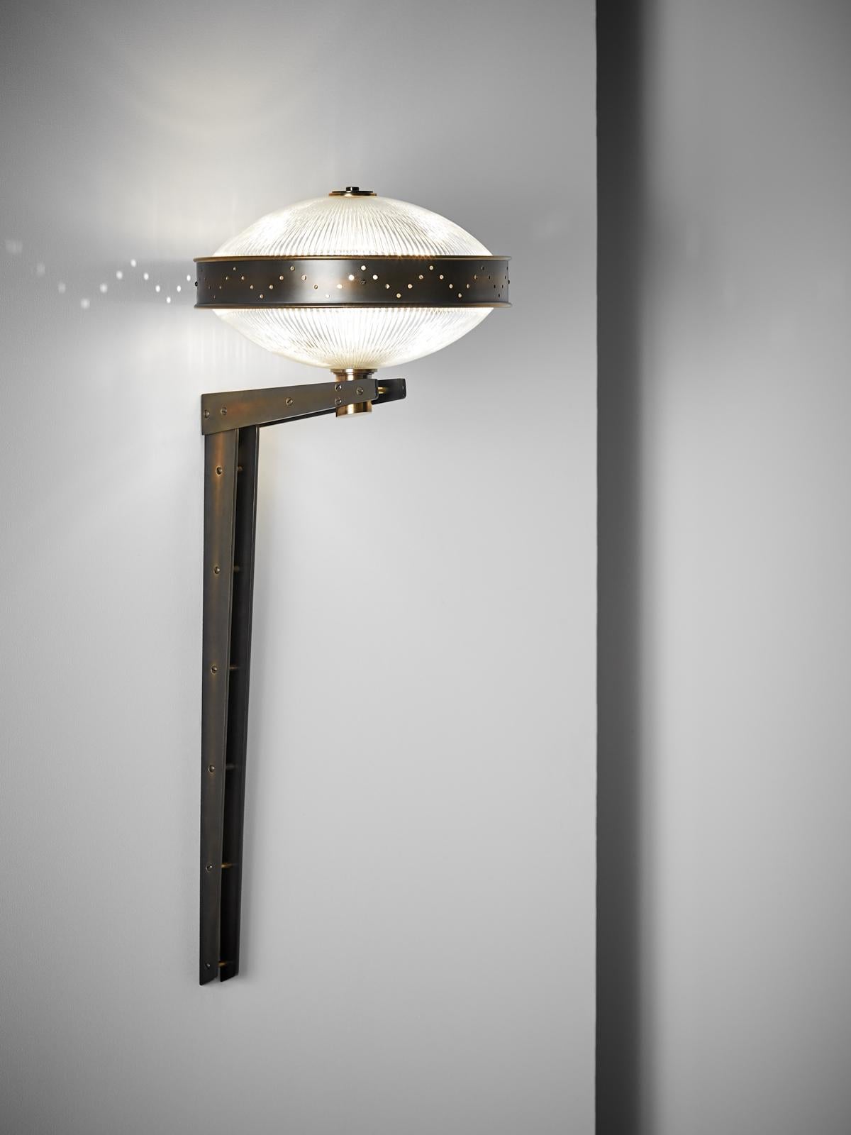 And Objects, product design studio founded by Martin Brudnizki and Nick Jeanes based in London.

Constructed from solid brass and featuring Holophane glass, the Bramdean Wall Light’s tall Industrial frame helps support the counter levering arm on