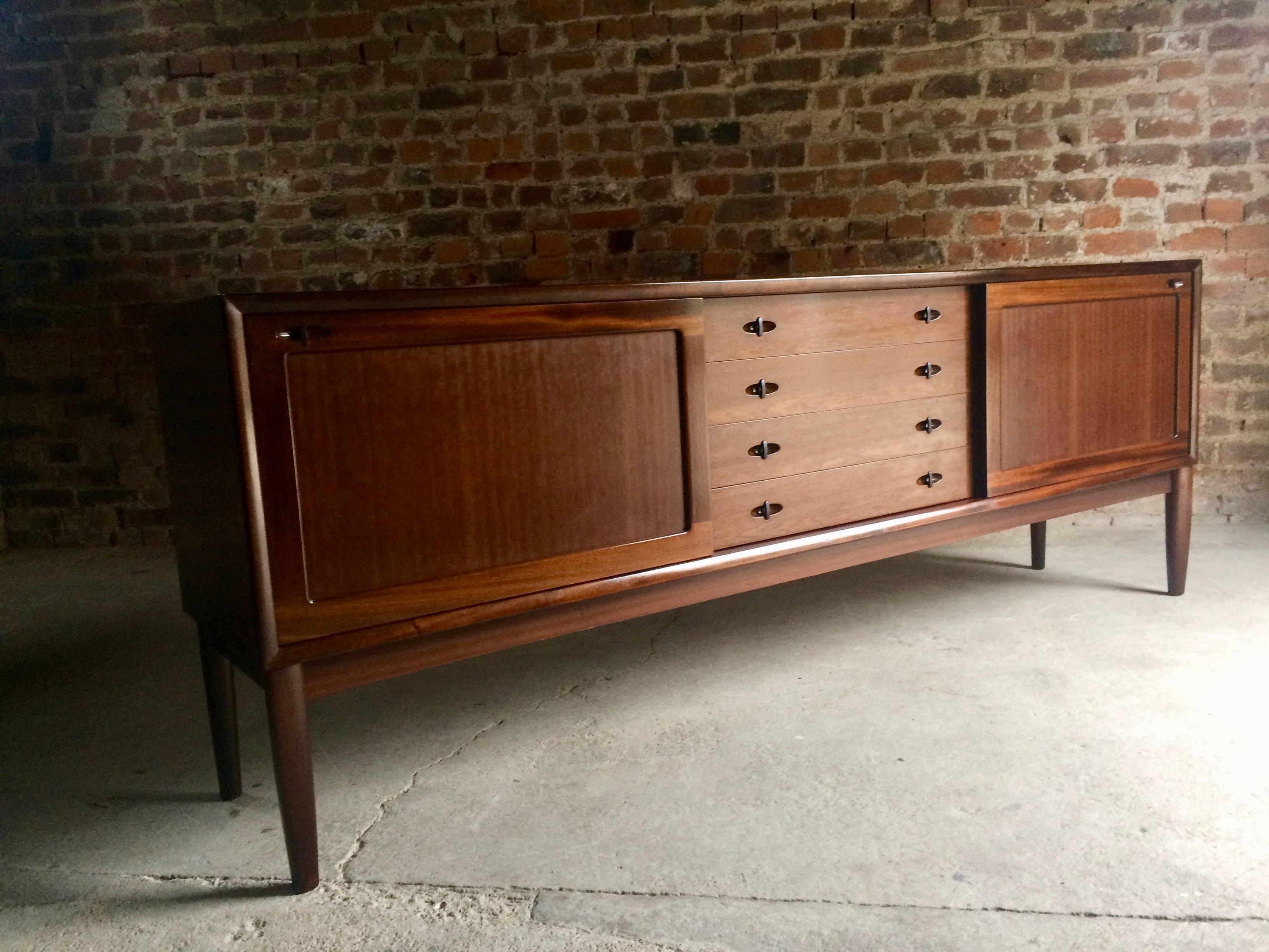 Magnificent classic Danish modern midcentury solid dark teak sideboard credenza designed by H.W. Klein and manufactured by Bramin, the rectangular top over two large sliding doors with adjustable interior shelving, flanking a flight of four central