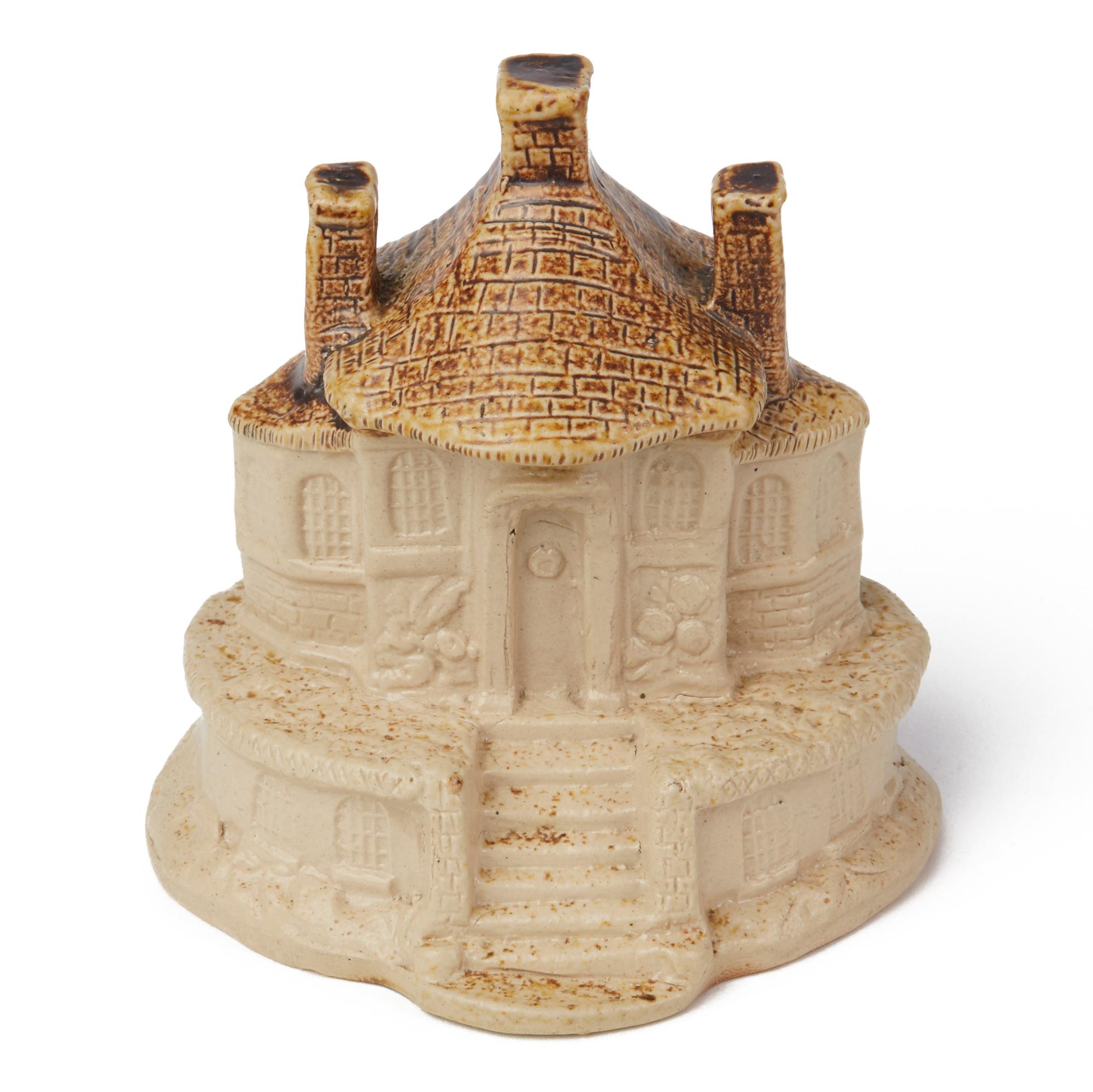 A rare antique Brampton, Derbyshire, salt glazed stoneware model of a cottage raised on an oval shaped base with good detail with a natural salt glazed finish the roof with a contrasting brown glaze. The model is not marked and dates between