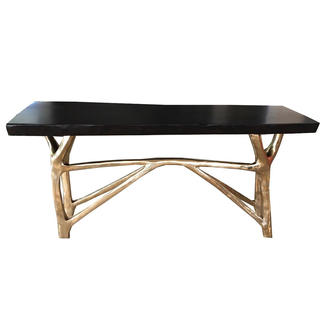 Console with cast bronze base and live edge exotic hardwood or black walnut top.