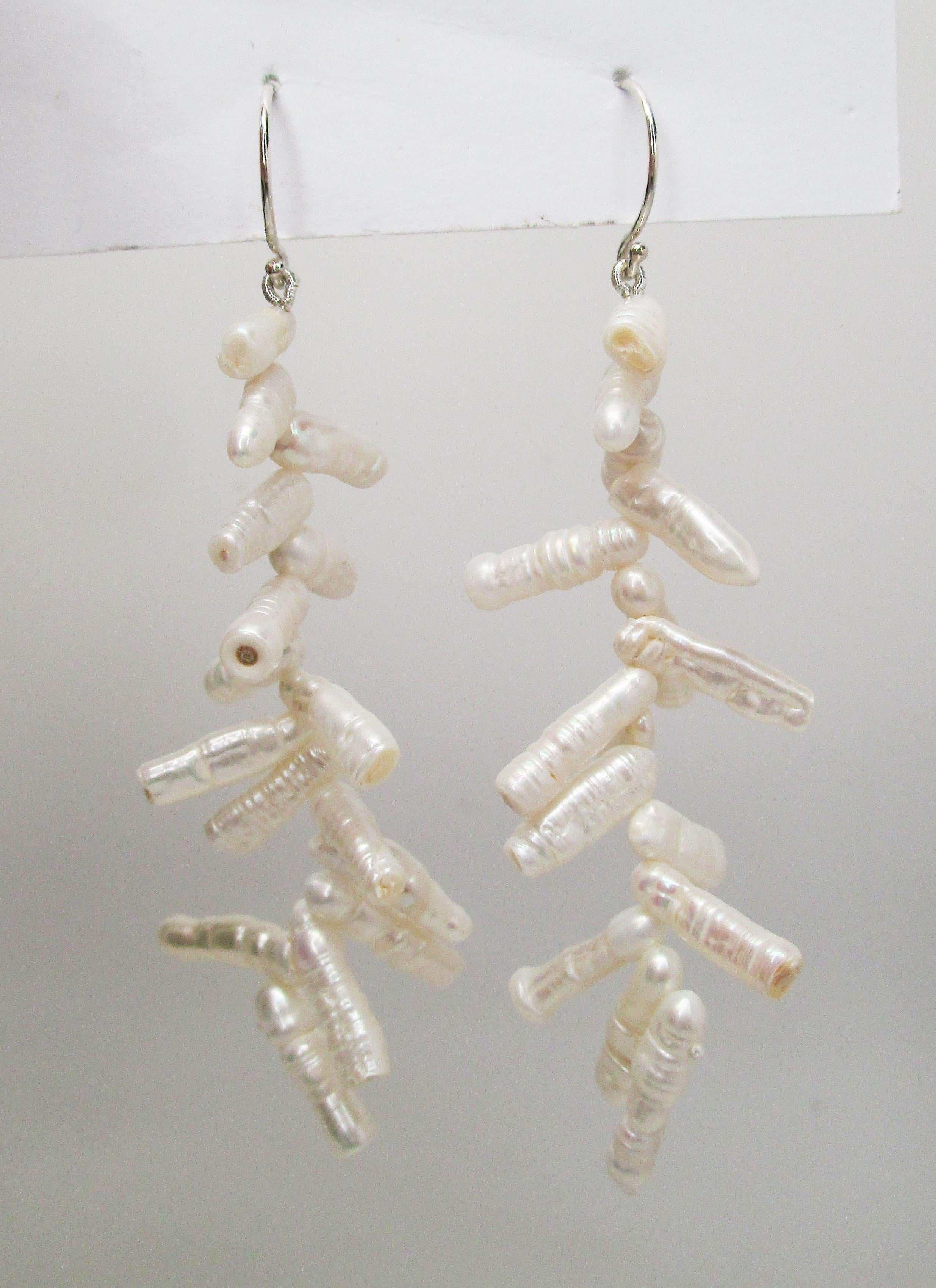 This remarkable pair of dangle earrings features sterling silver shepherd’s hook wires and a stunning array of brilliant white branch pearls. The pearls have an incredible luster and a stunning white color! These unique earrings allow for a lovely