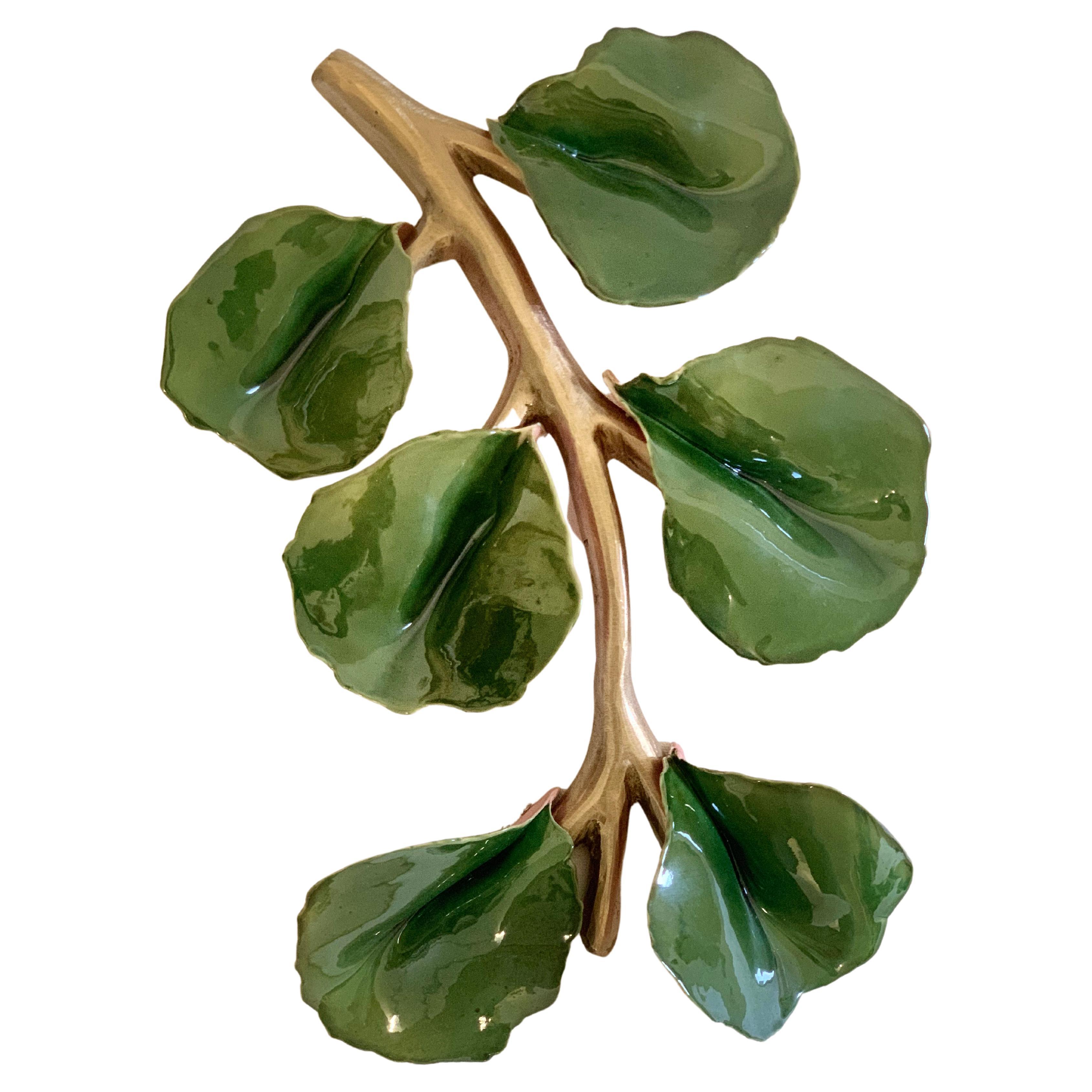 This is a custom sculpture and decorative object cast in solid bronze with green ceramic leaves. The ceramic leaves have been beautifully fired to achieve a high gloss green. Bronze has been polished and sealed to a high polish.