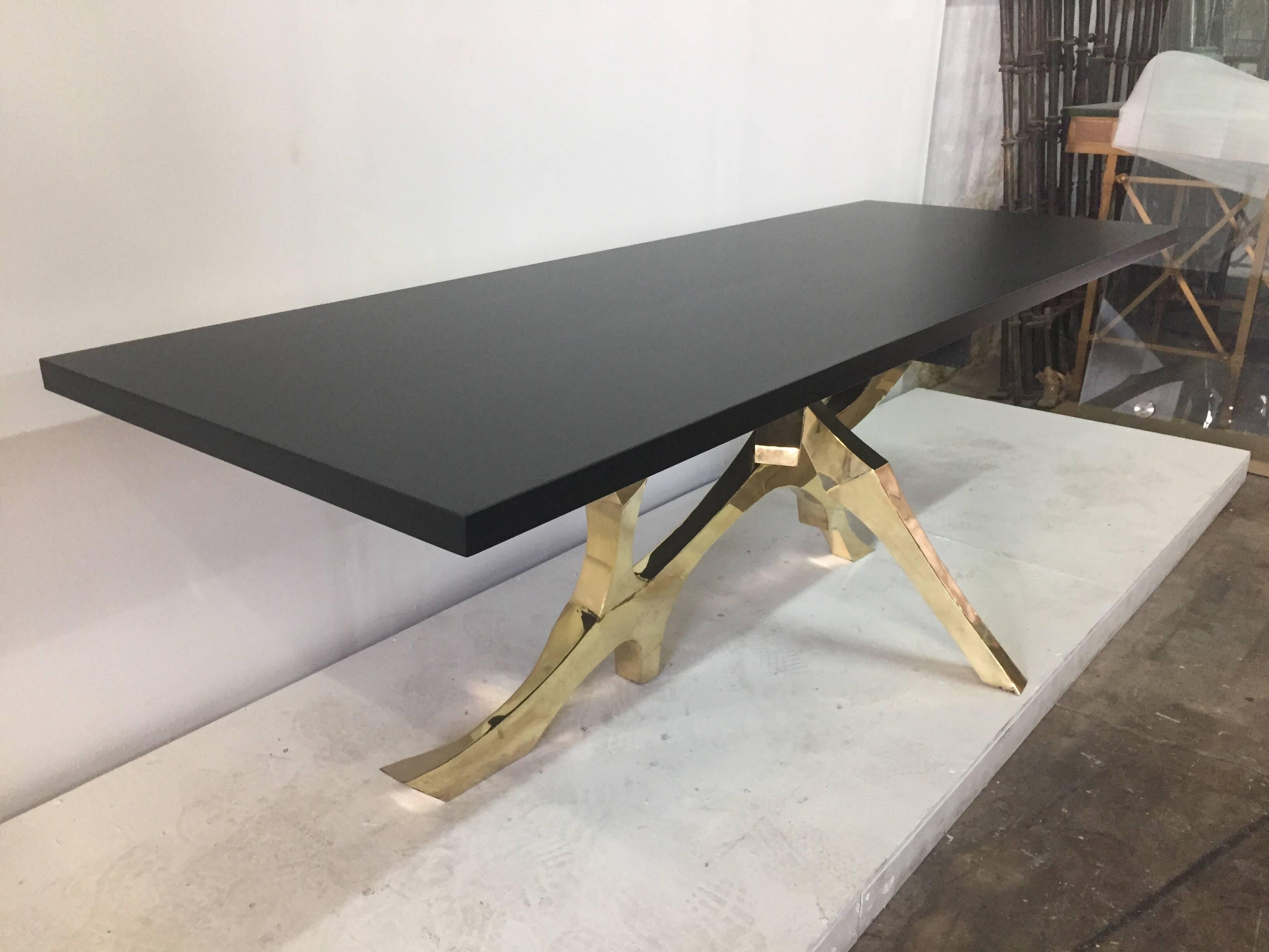 This whimsical and important organic designed table base in brass is topped by a black matte finish wood top. Has been polished but not lacquered so it will take on a patina over time.

Note: the base legs are wide in one area that kicks out