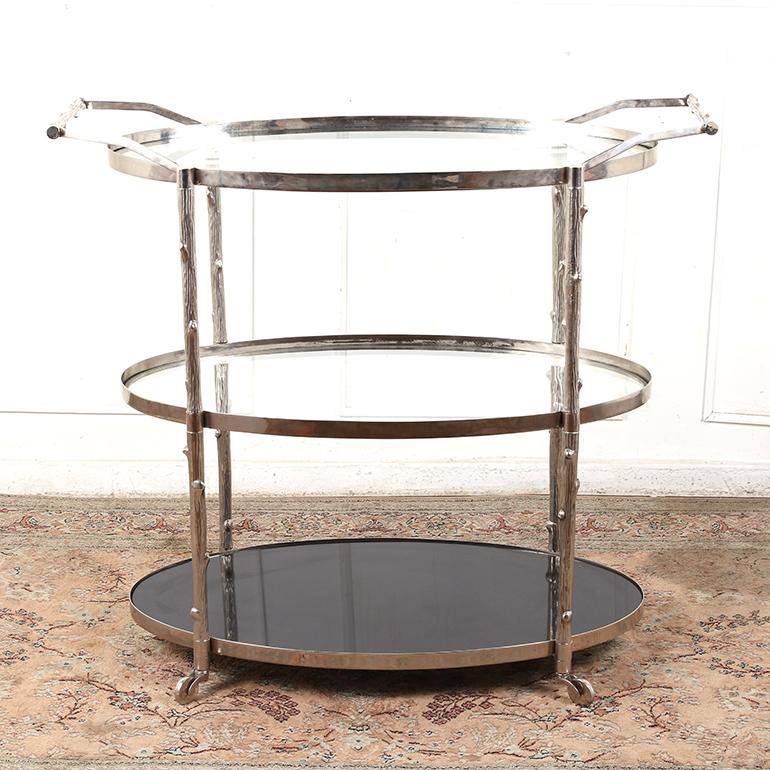 This nickel plated bar cart by “Global Views” has branch textured detailing on the frame and handles, a black granite bottom shelf, and two tempered glass upper shelves.

Global Views is known for their exquisite home furnishings and accessories.