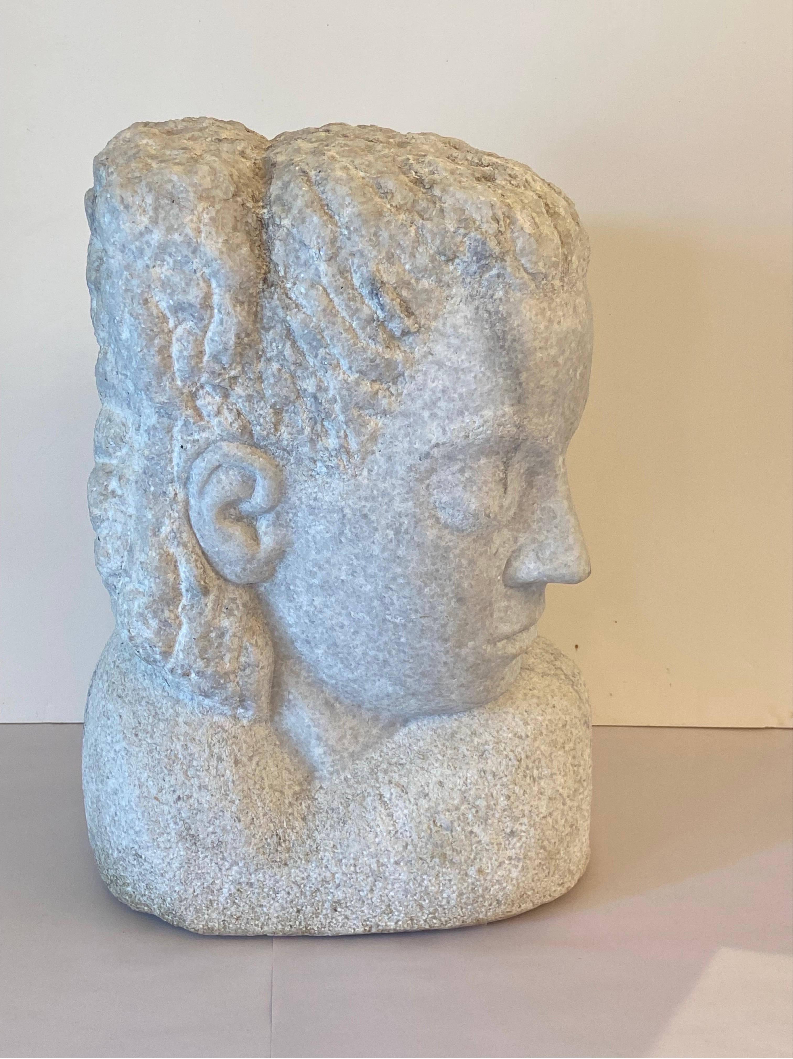 Well portioned modernist sculpture of a woman in the early art deco style.. An intense face with strong chisel marks and fine detail… Circa early 20th century.
