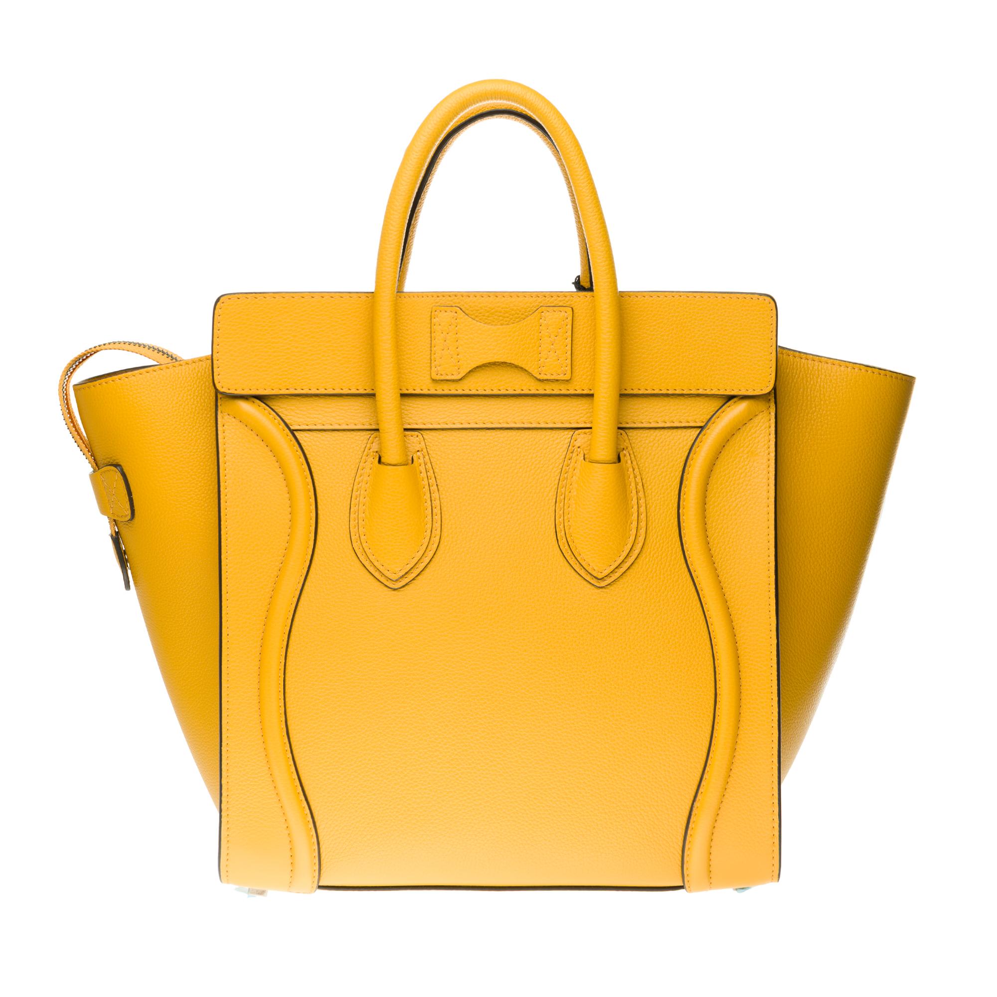 The iconic Céline LUGGAGE Mini handbag in Yellow Ochre calfskin with a handle, zipper and zipper pocket on the front.

31 X 31 X 18 CM (12 X 12 X 7 IN)
CALF
CALF LINING VELVET STYLE
SILVER FINISH
HAND HELD
ZIP FASTENER
ONE ZIP POCKET AND TWO