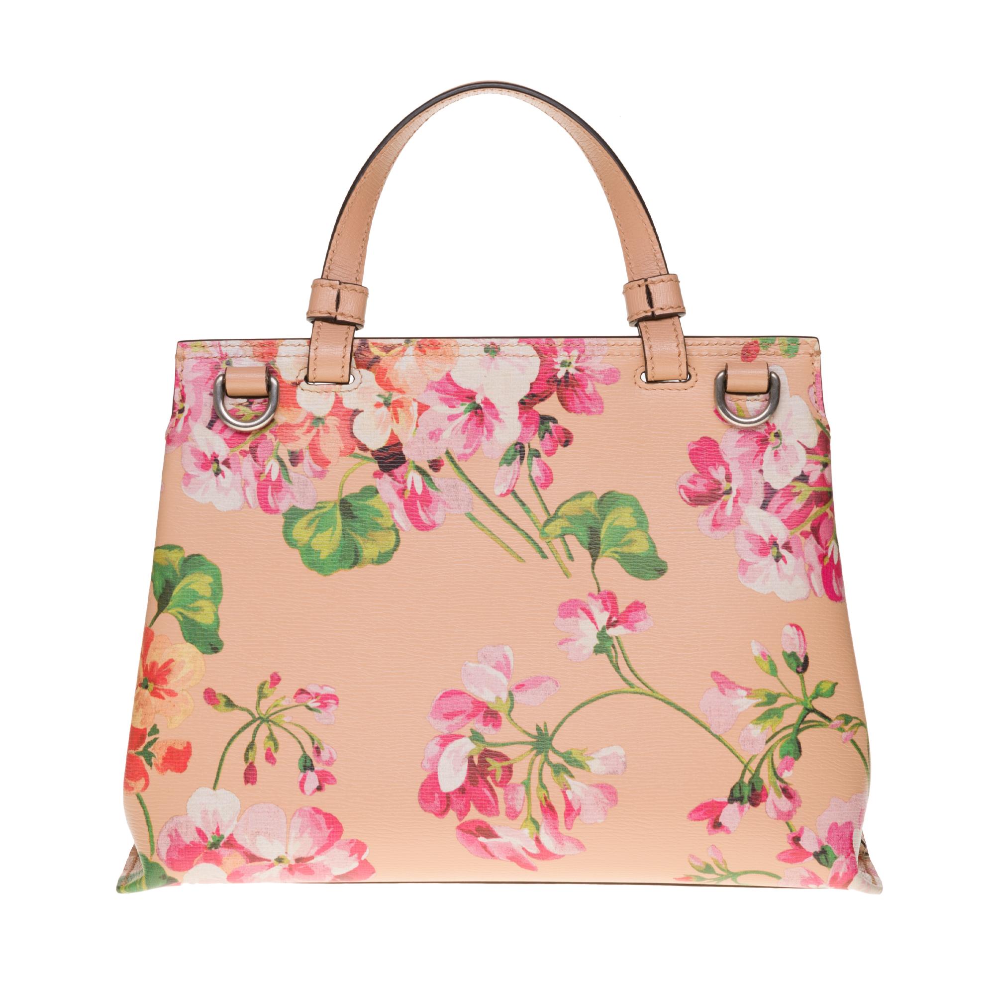 This chic shoulder bag is crafted of beautiful calfskin leather in blush pink with a floral print. The bag features leather top handle, a looping end to end long shoulder strap and a facing flap pocket with a weighted bamboo closure. The flap opens