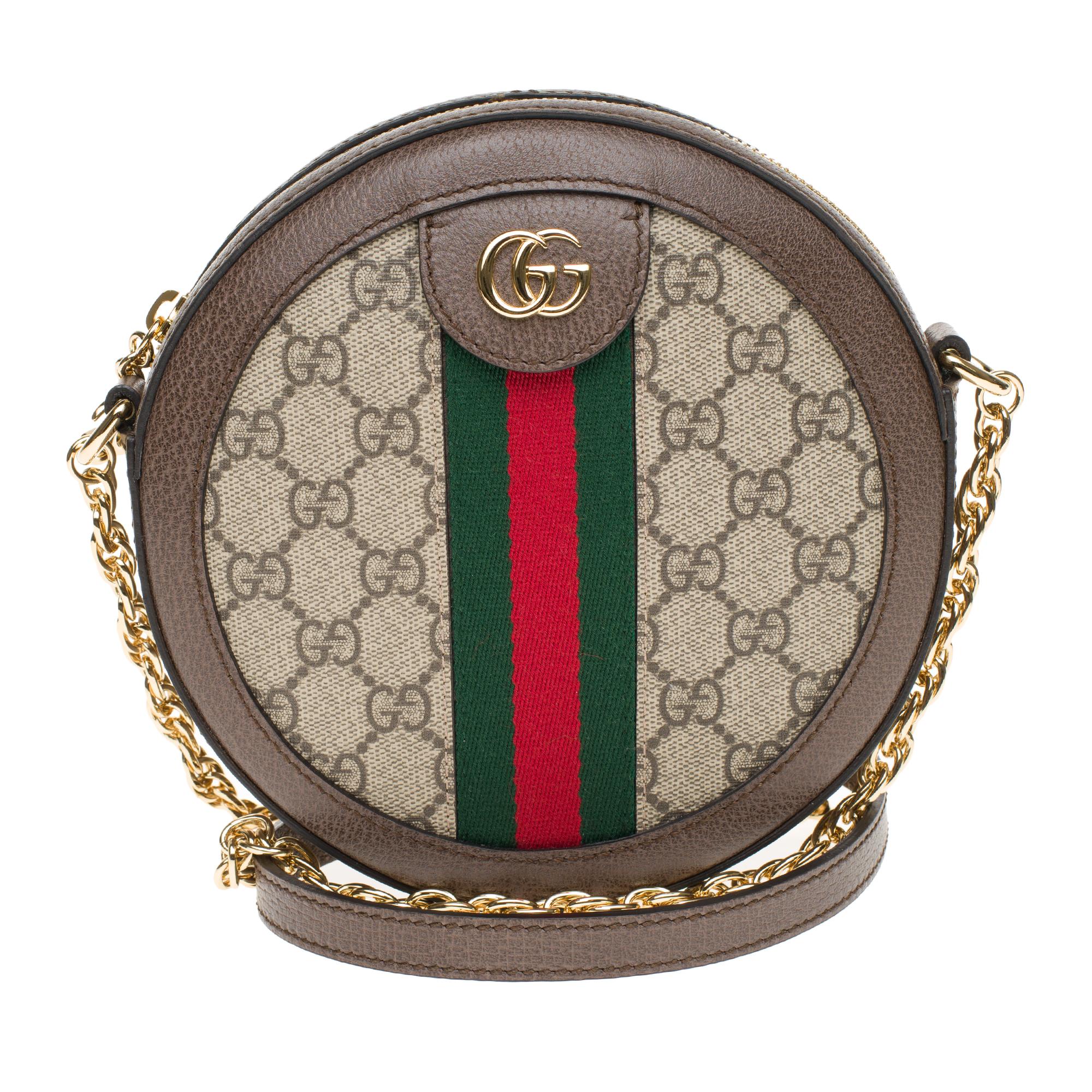 Gucci Ophidia bag round, embellished with a chain shoulder strap.
Crafted from Supreme GG canvas, inlaid with green and red web tape, the accessory features Double G detail from the Gucci archives of the 1970s. Revisited in a smaller version, it is